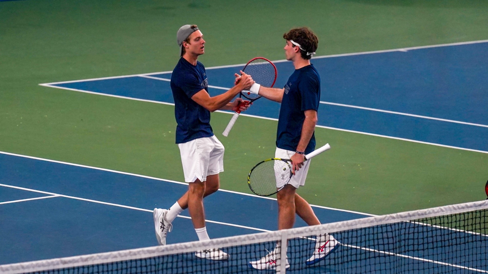 Diego Laporta and Alex Martinez Sanz slap hands after a point on the tennis court