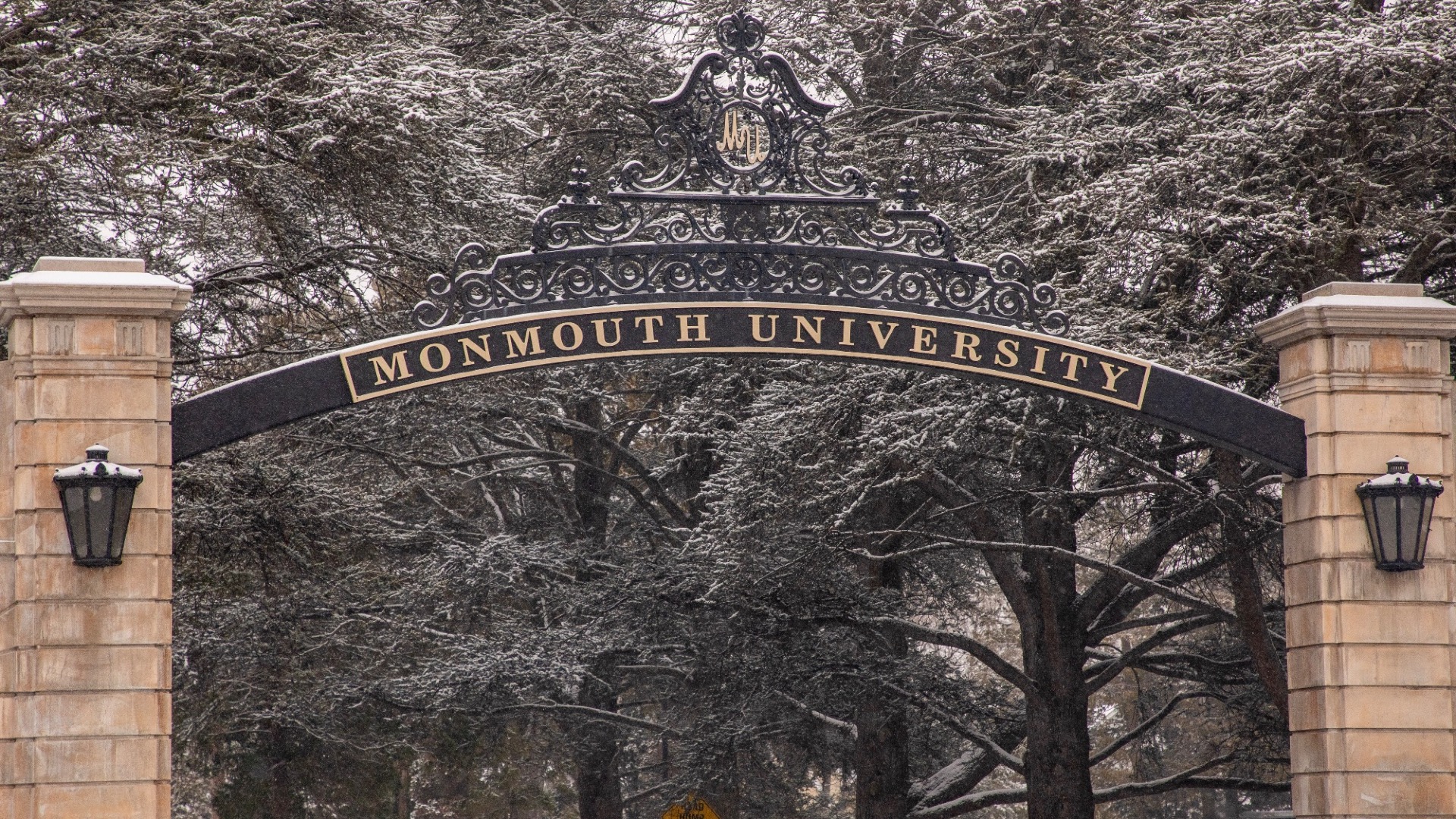 Monmouth University gate with snow in trees (Campus Shots)
