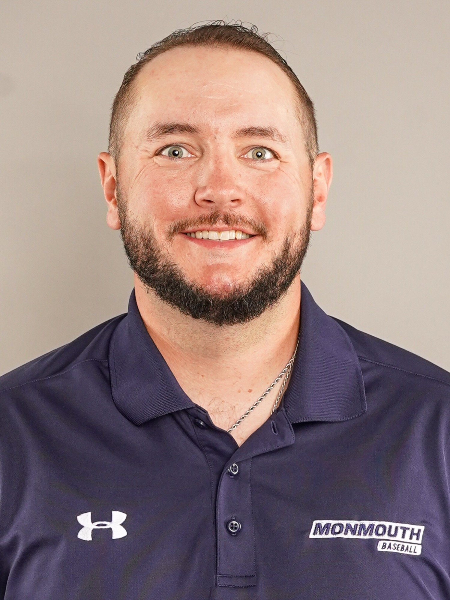 Eric Reardon (head and shoulders mug shot in a blue polo with a white Monmouth baseball logo)