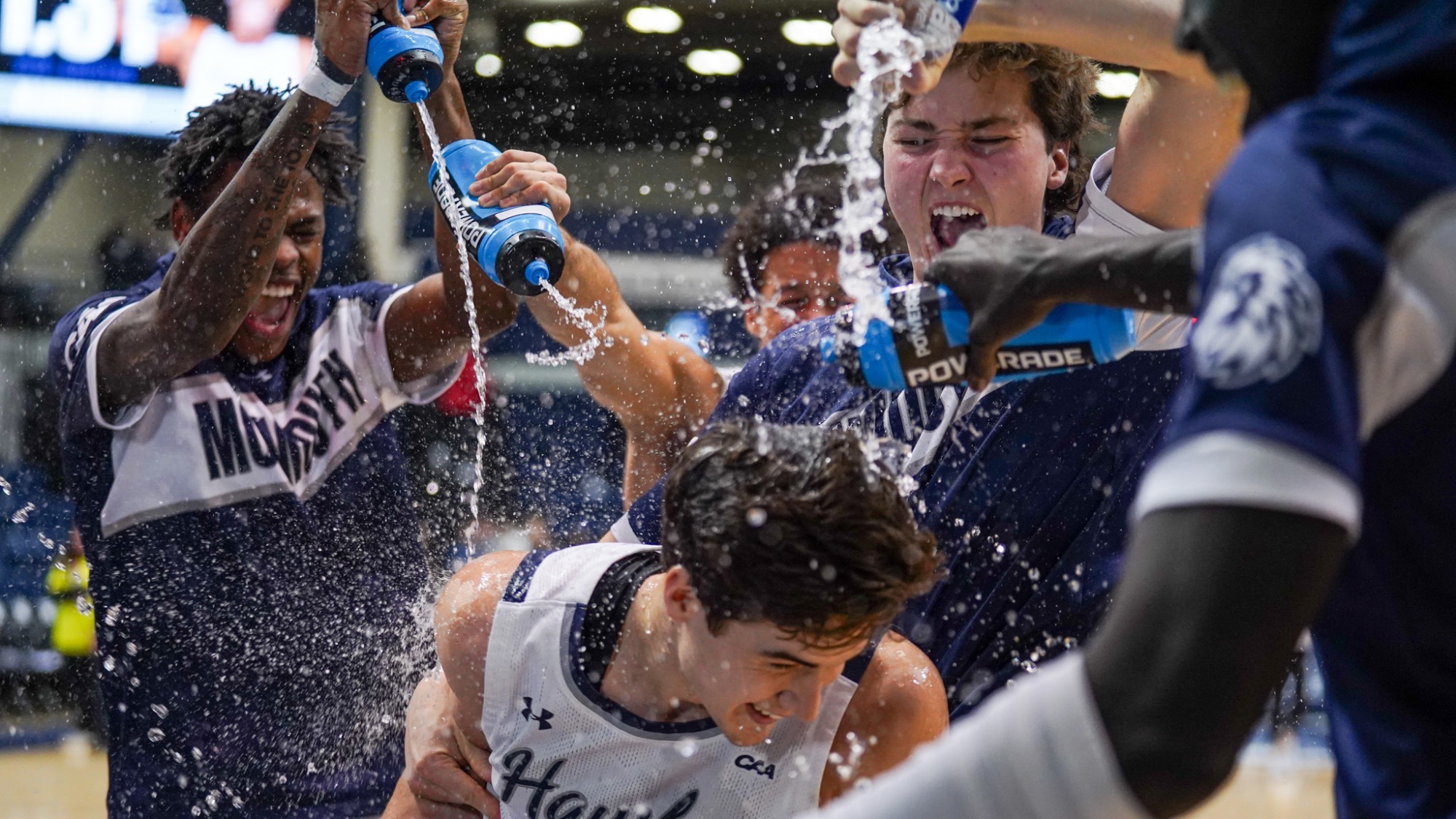 The men's team pours on water on Corey Miller after his buzzer beater