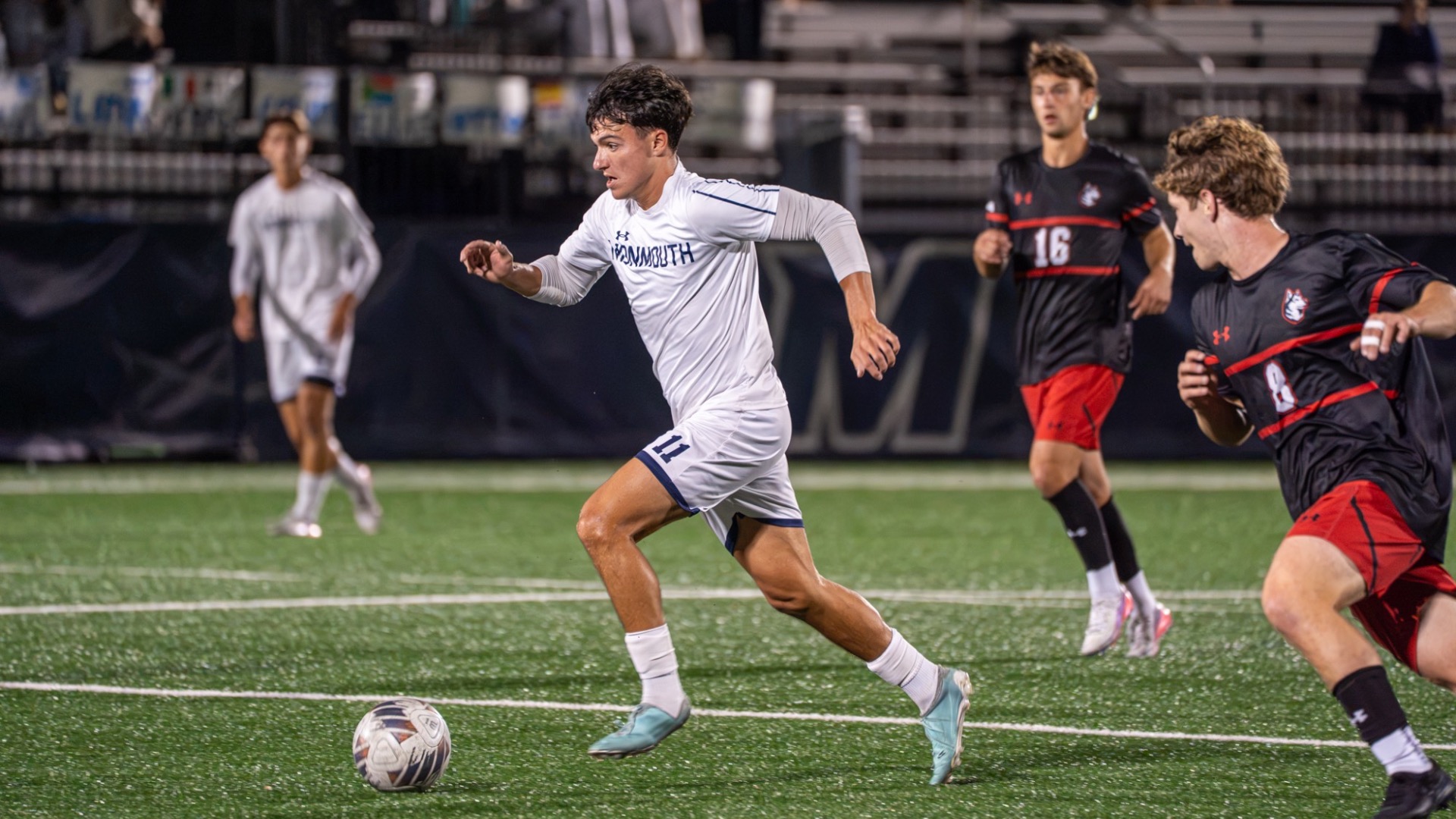 Jessy Bichler runs down field with the ball and defenders trailing
