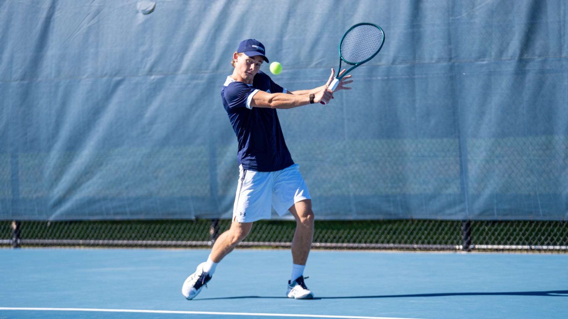 Axel Engstrom hits a ball with his racquet