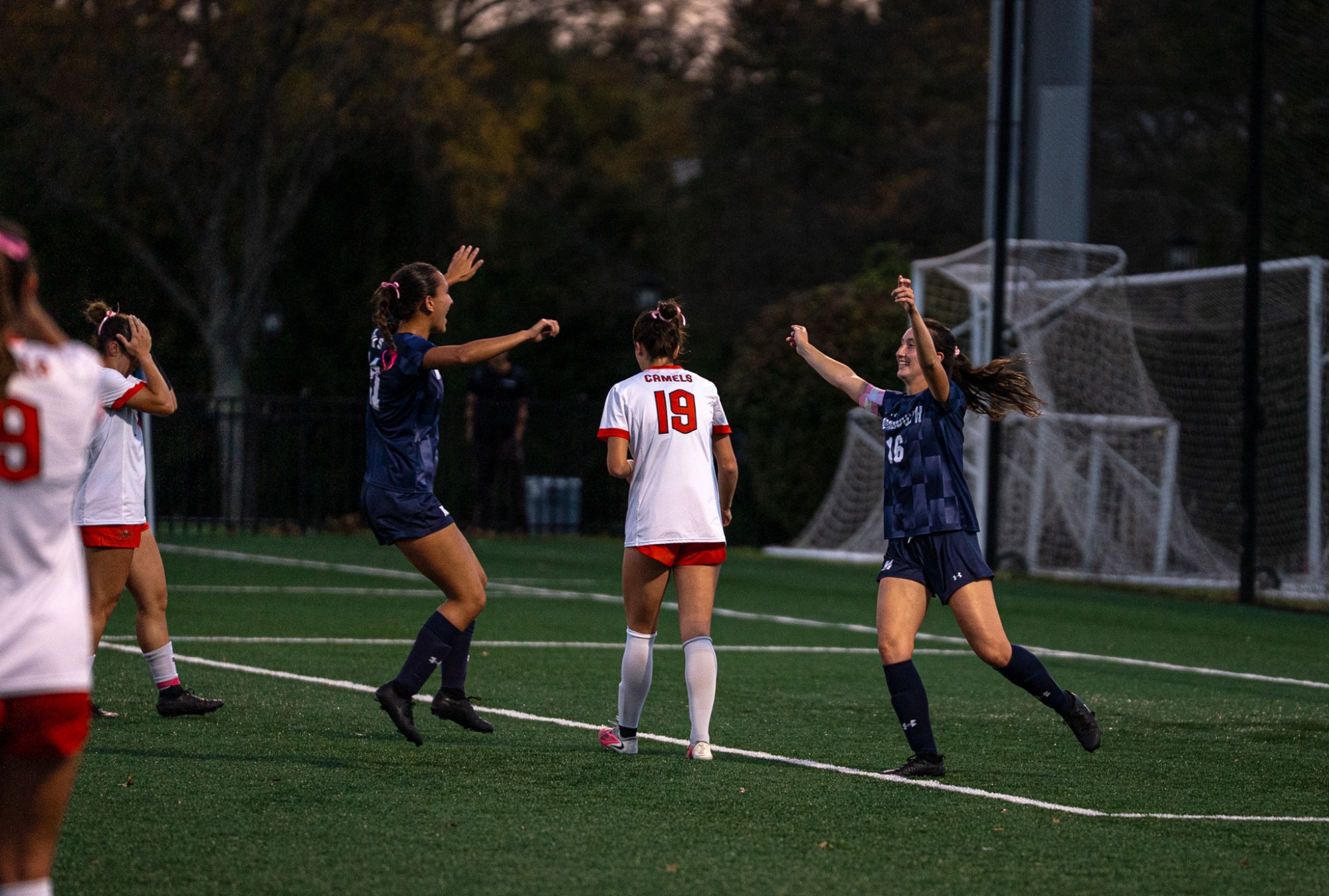 Emily and Brooke De Almeida celebrate after a goal 