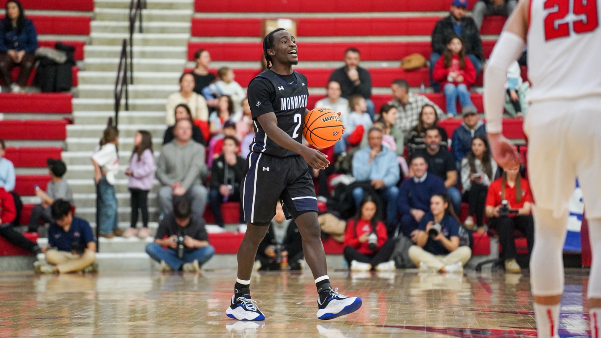 Kavion McClain yells out as he dribbles the ball up court