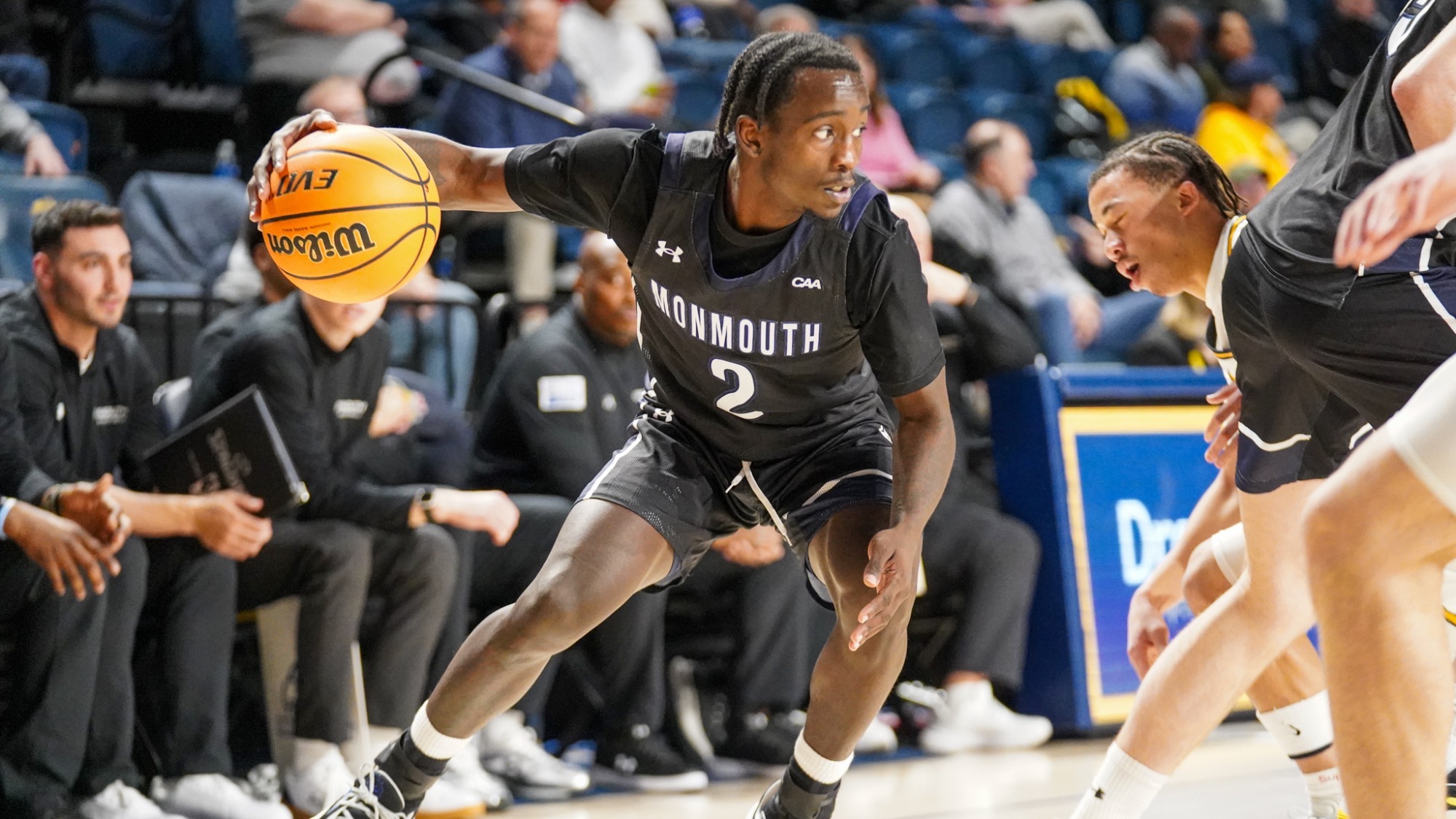 Kavion McClain holds the ball out looking to go around a defender