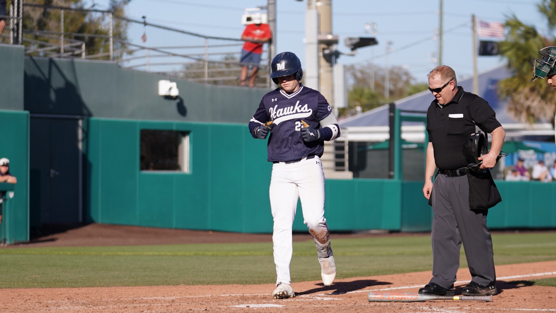 RJ Mustaro steps on home plate after a home run
