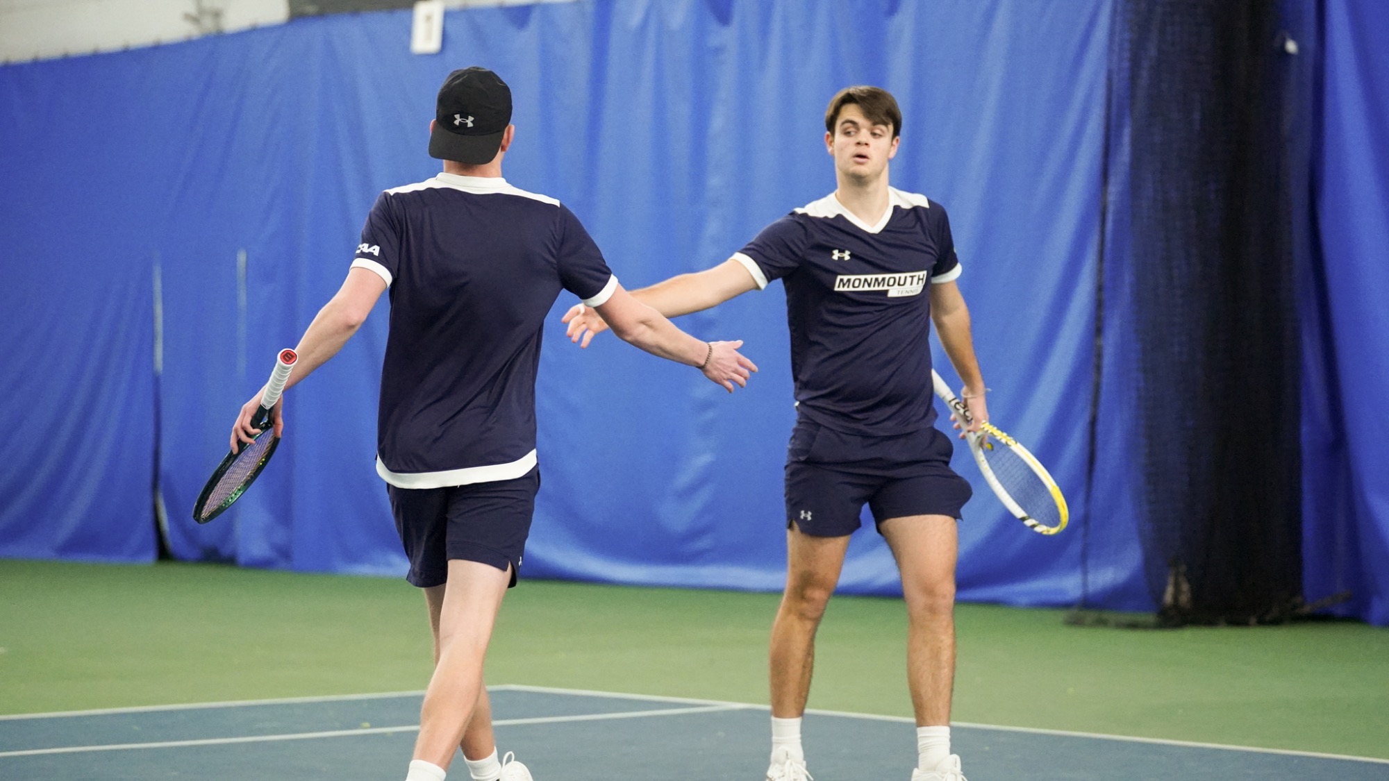 Jakob Bonnett and Louis Keller high five after a point