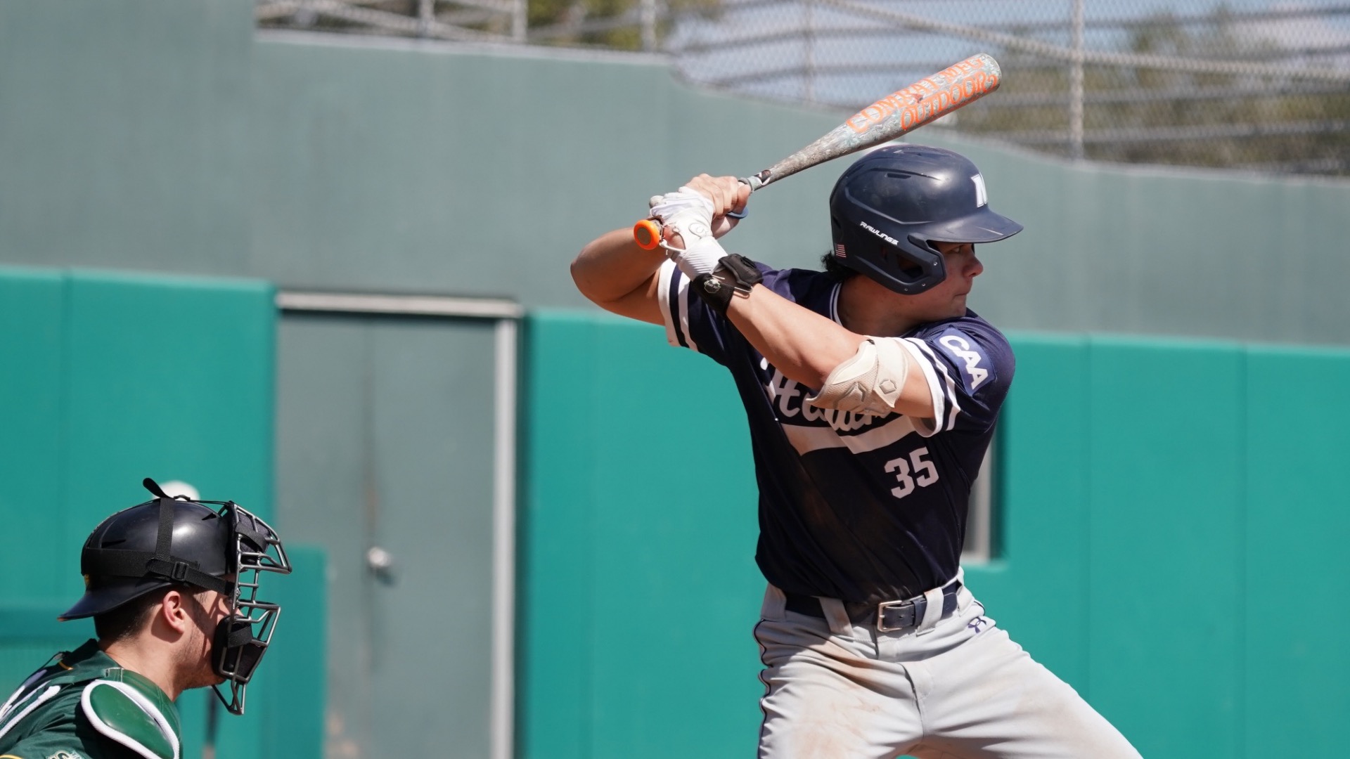 Robert Kelly stands with the bat on his shoulder ready to hit
