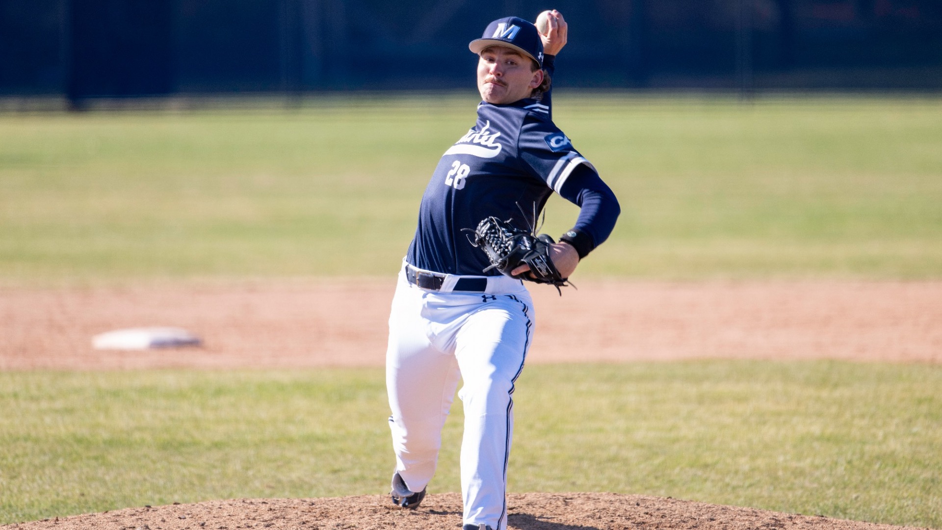 Drew Yagodzinskie pulls his arm back and throws a pitch towards the plate