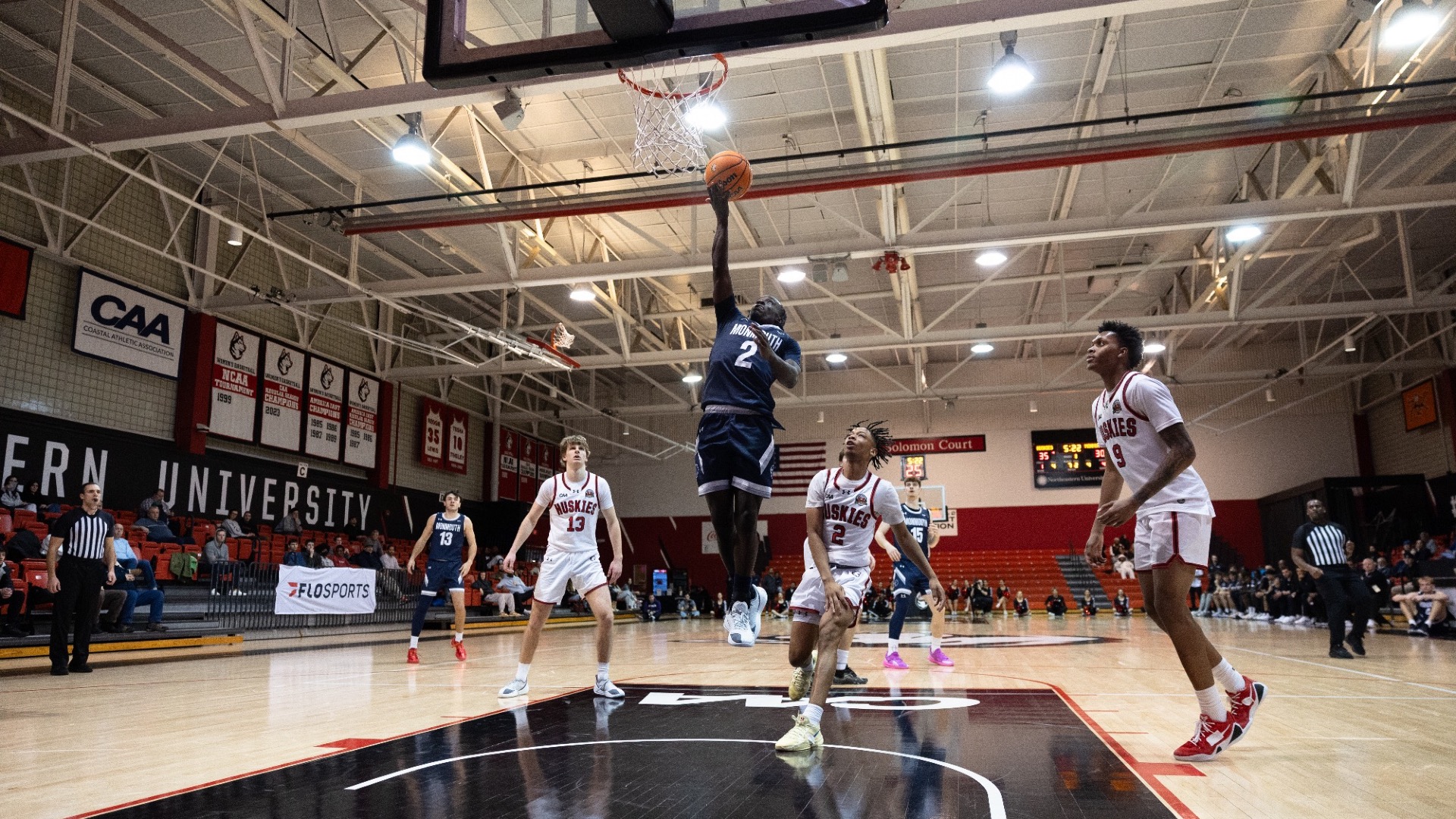 Kavion McClain drives to the basket while other players look on