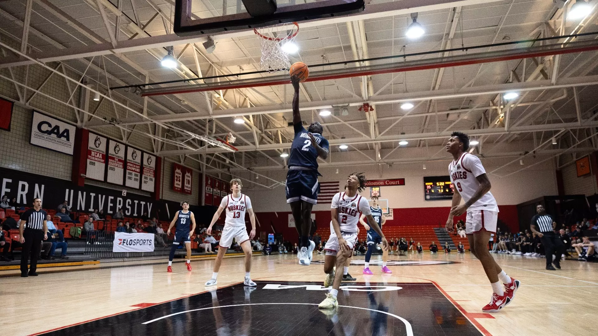Kavion McClain drives to the basket while other players look on