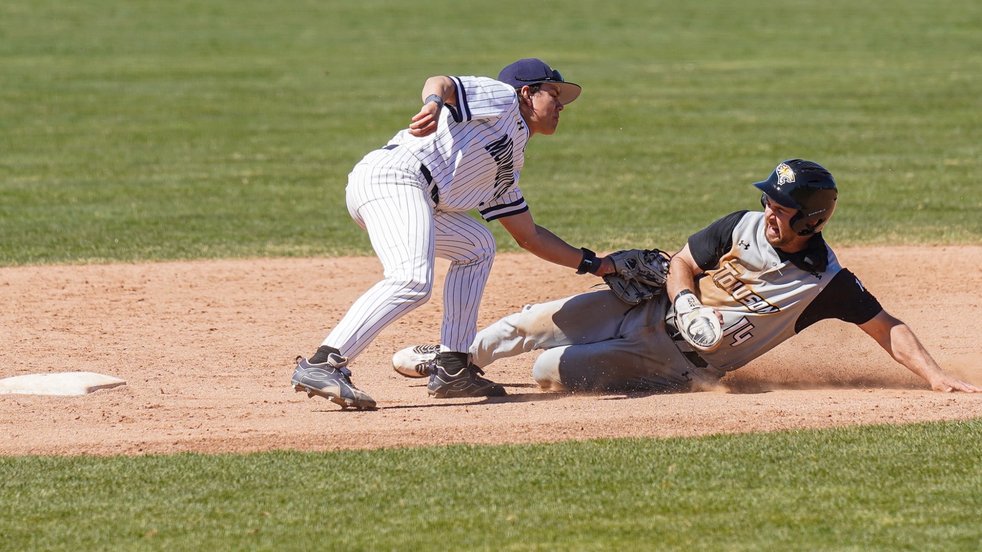 Wyatt Hunt reaches down to apply the tag on a runner well short of second base