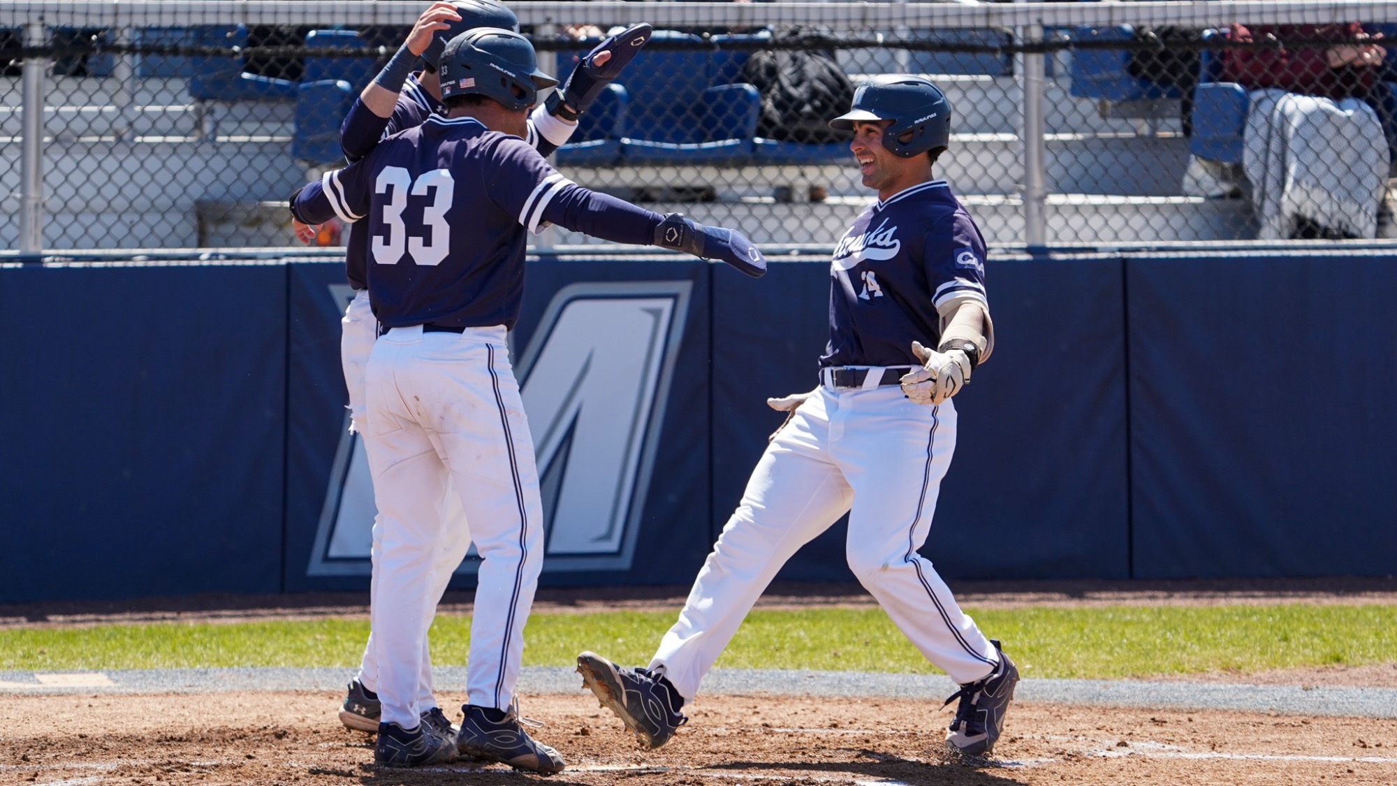 Simmi Whitehill and Chris Walsh celebrate with Nick Lovarco after a home run