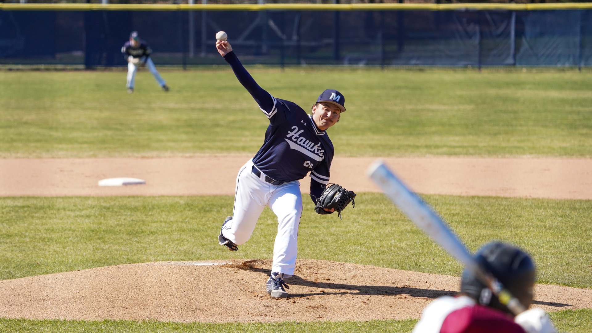 Drew Yagodzinski raises his arm over his head to throw a pitch