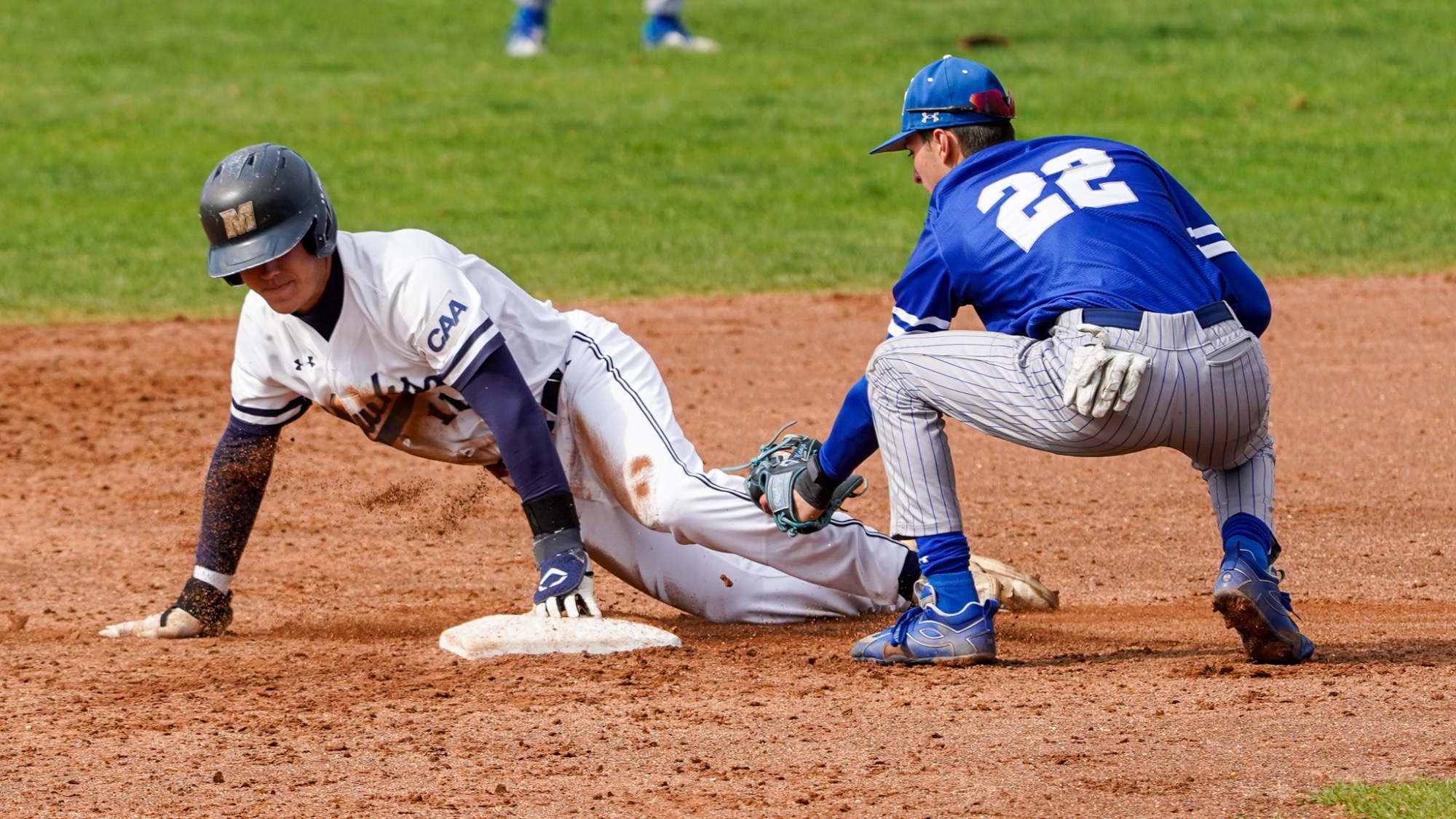 Aidan Bretschneider slides into second base as the other team applies the tag