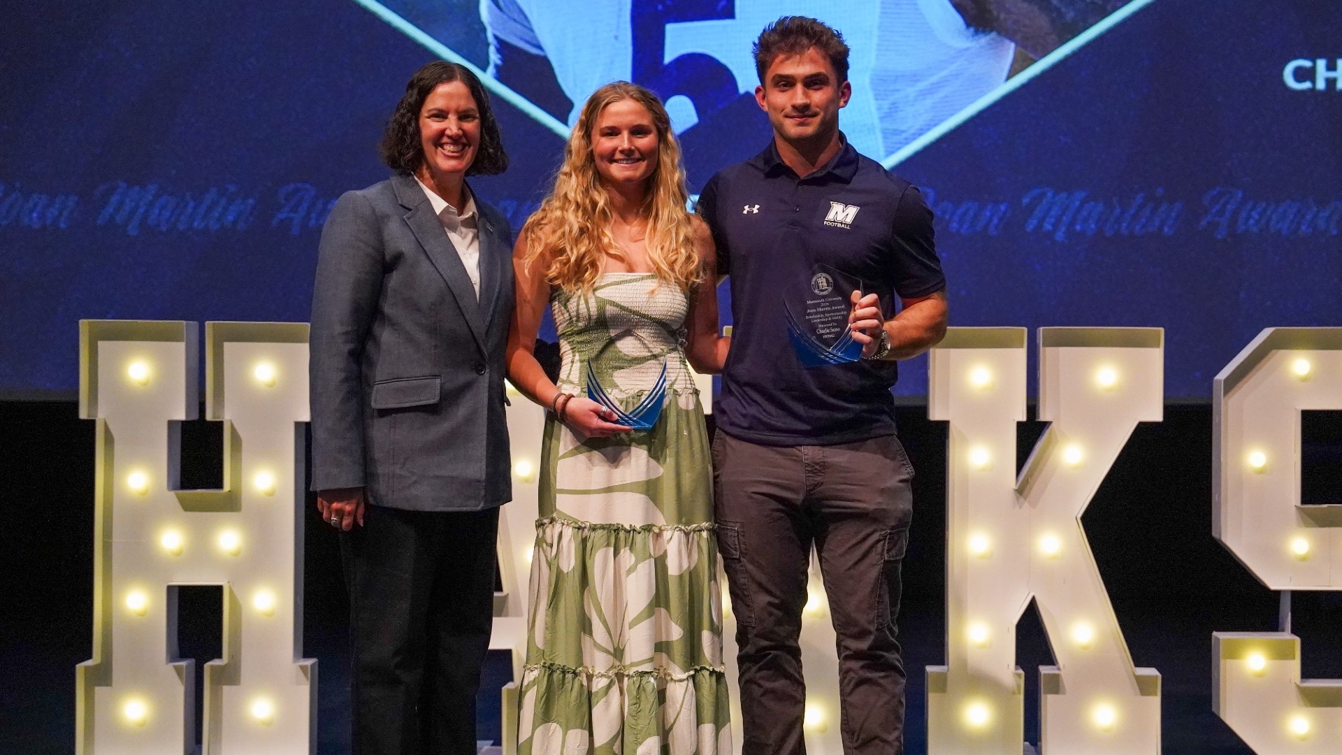 AD Jen Sansevero stands with Joan Martin Award Winners Grace Curtin and Charlie Sasso