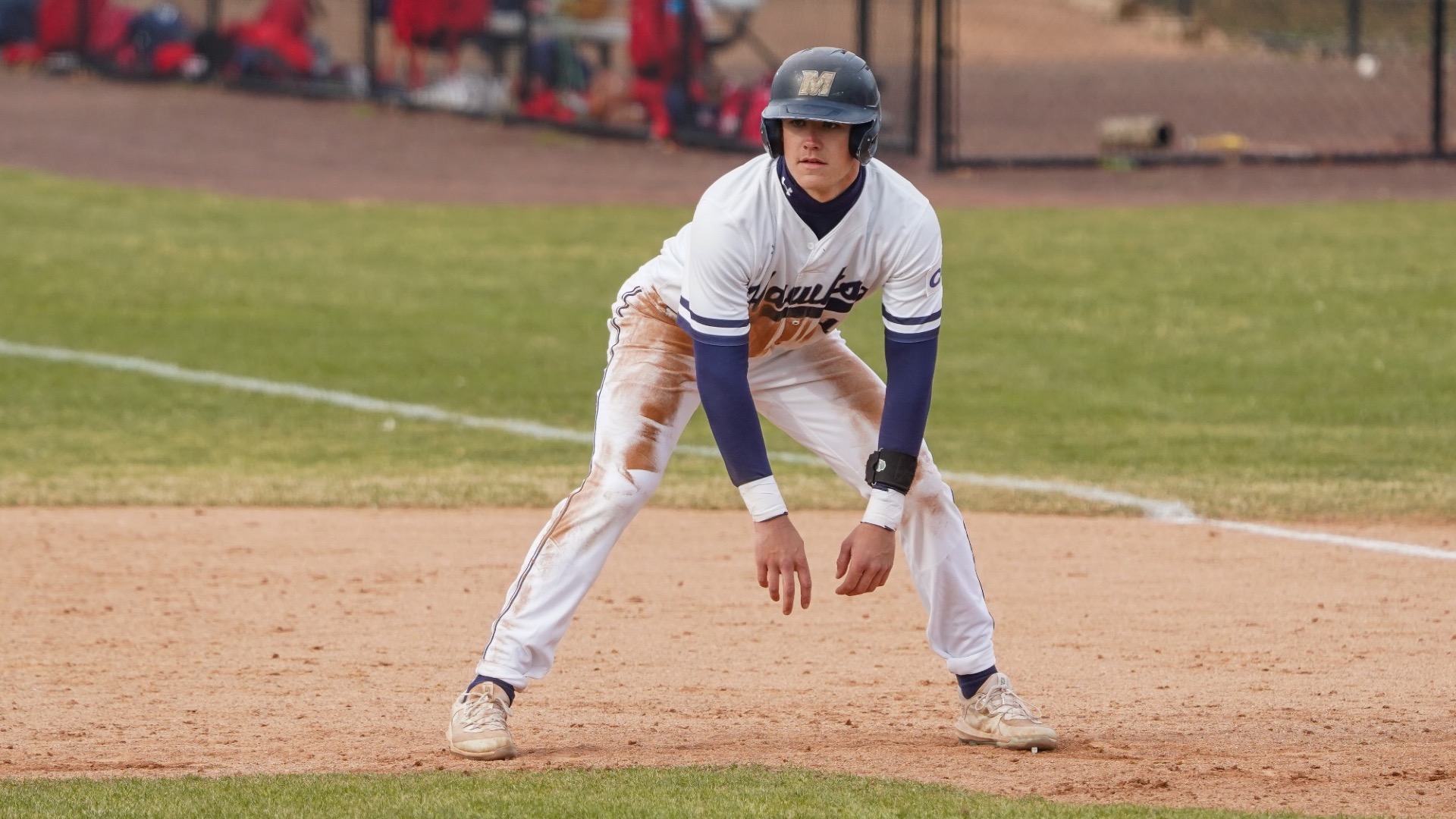 Aidan Bretschneider leads off a base with his hands dangling in front of him