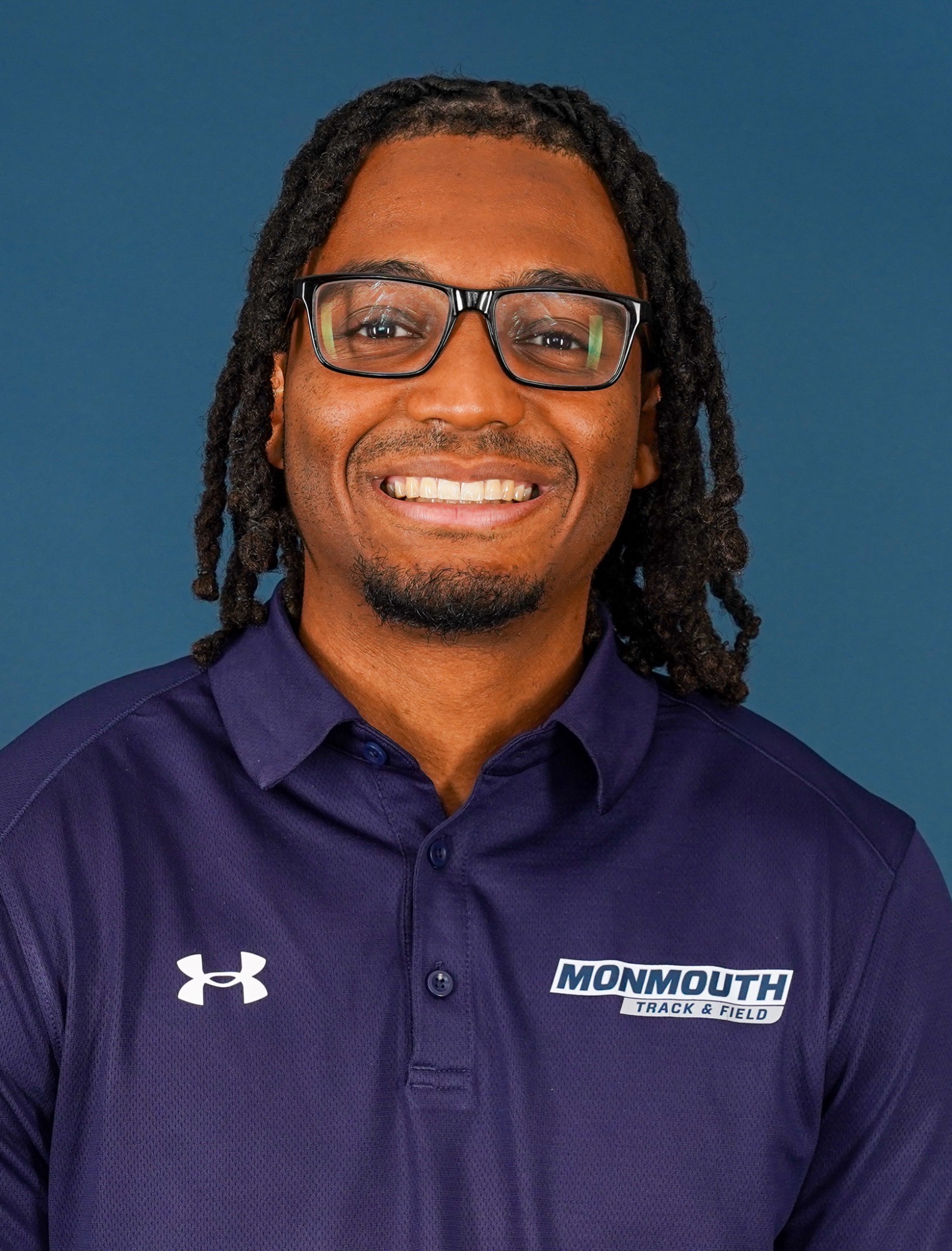 Jordan Torney Headshot 2026 (head and shoulders mug shot in a blue Monmouth track polo)