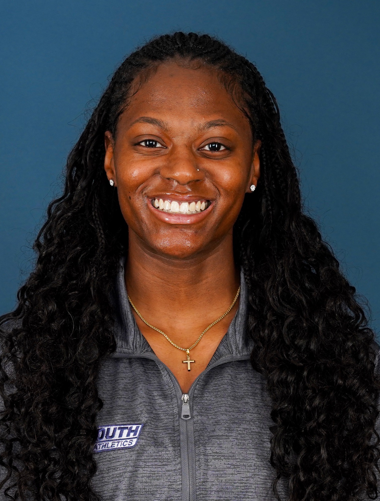 Alexis Andrews Headshot 2026 (head and shoulders mug shot in a gray quarter zip)