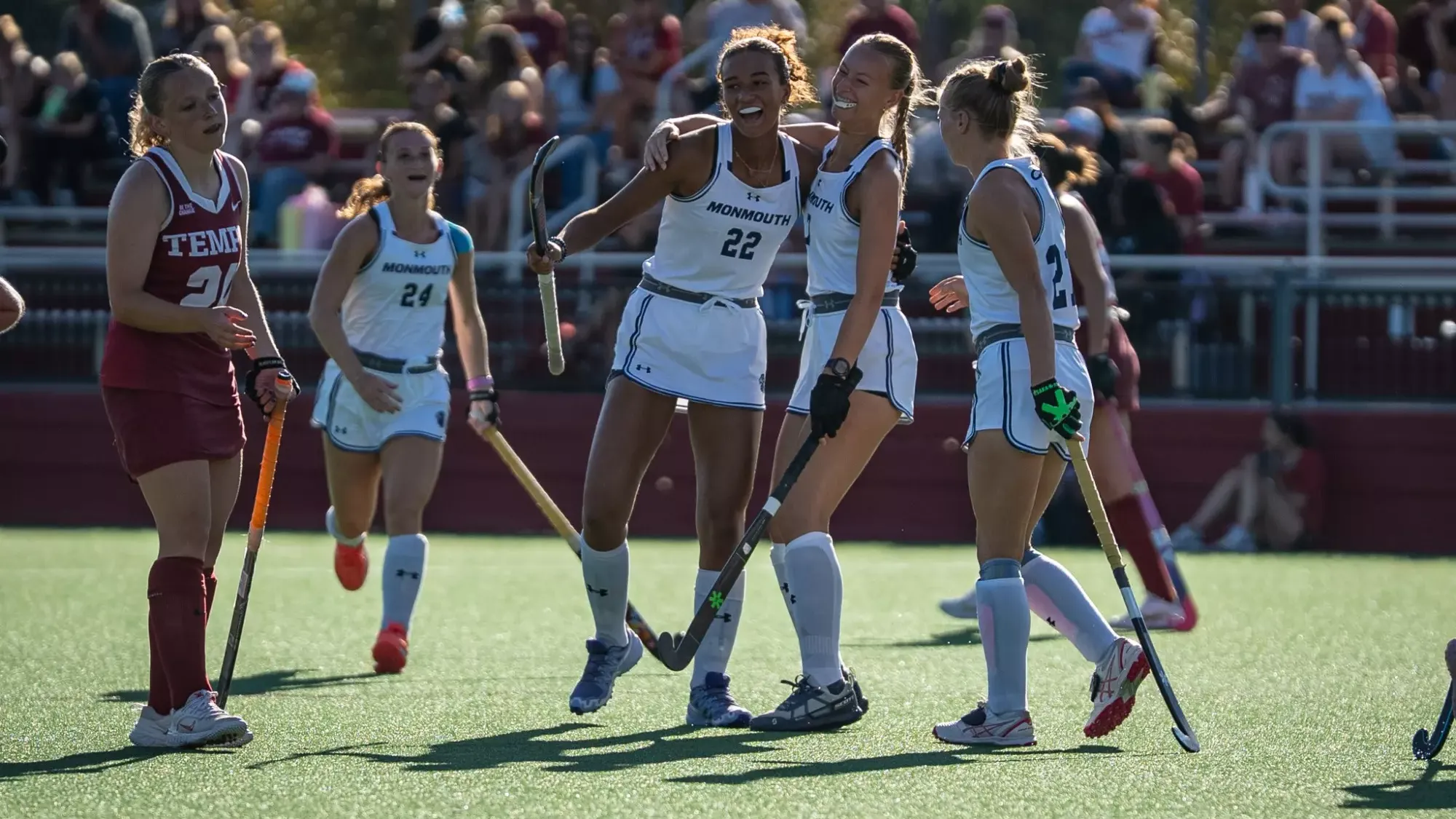 Alicia Vanderlyde, Lauren Relik and Stella Goddard-Despot celebrate after a goal 