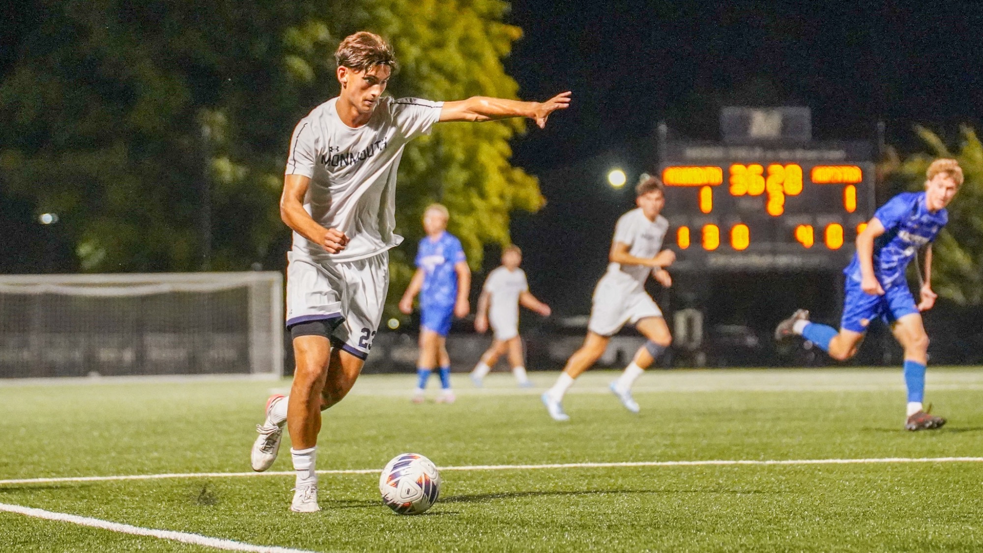 Brady Orendanc holds out a hand and prepares to kick the ball while other players race towards him