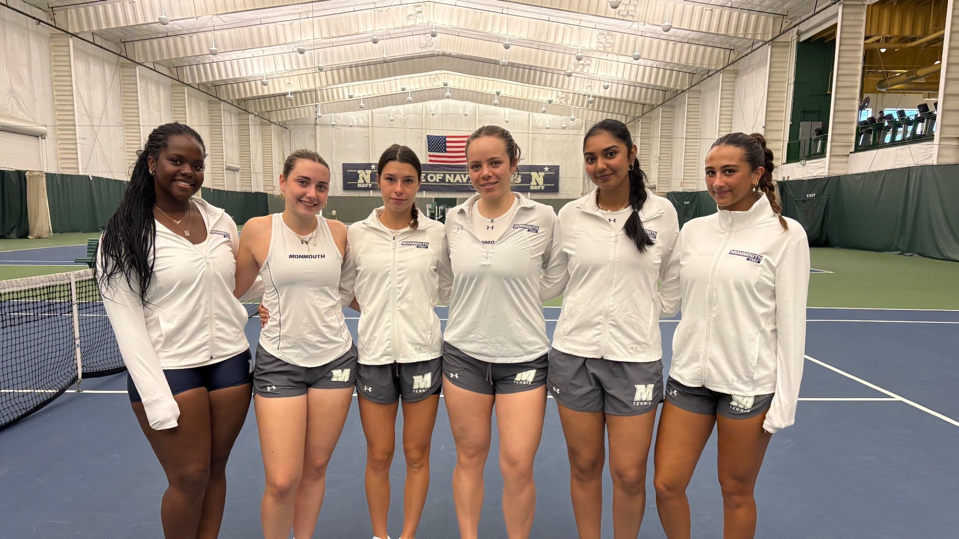 2026-27 Monmouth Women's Tennis Team Lined Up on the Courts at Navy