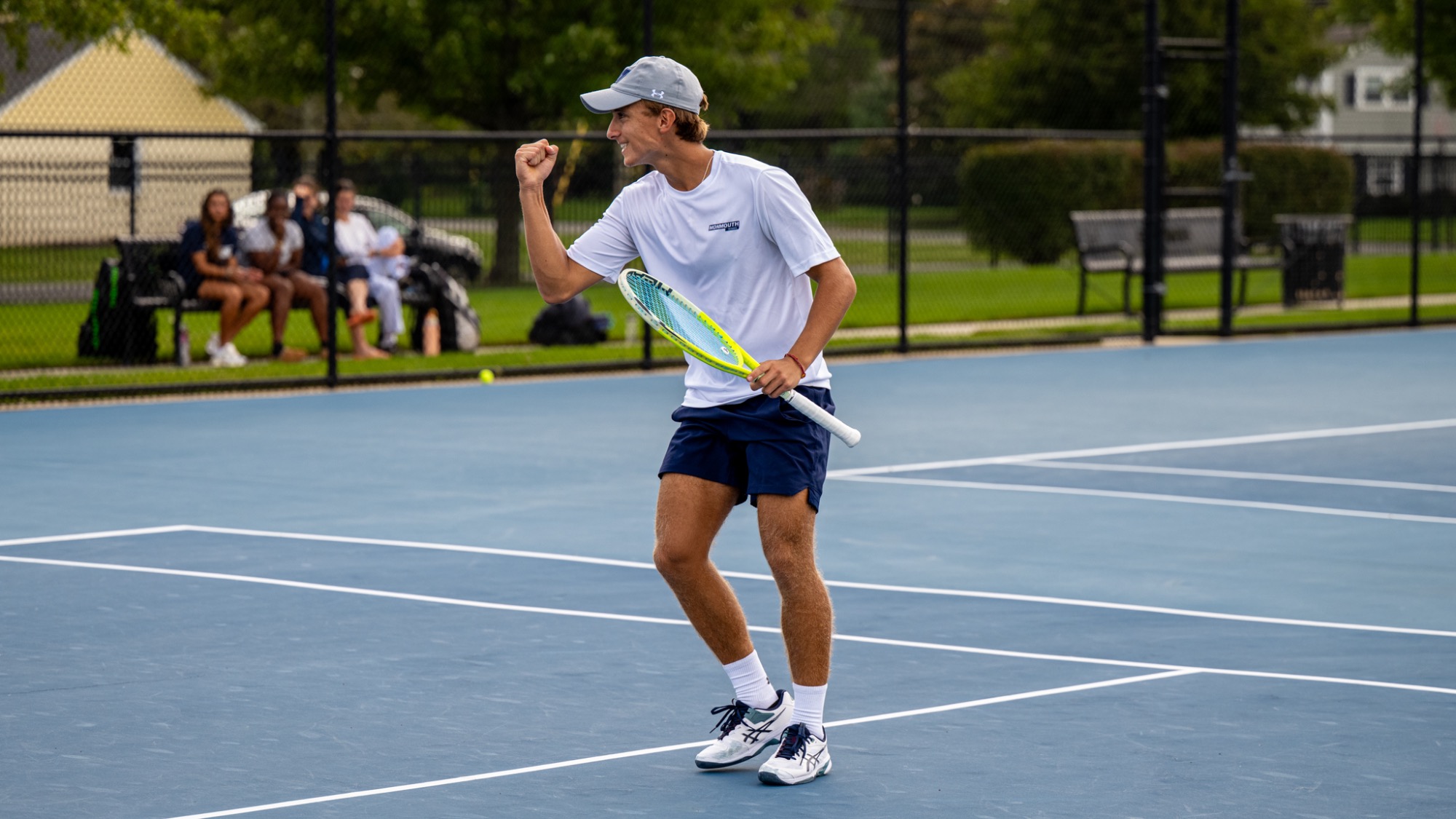 Santiago Ledesma fist pumps after a win on the tennis courts