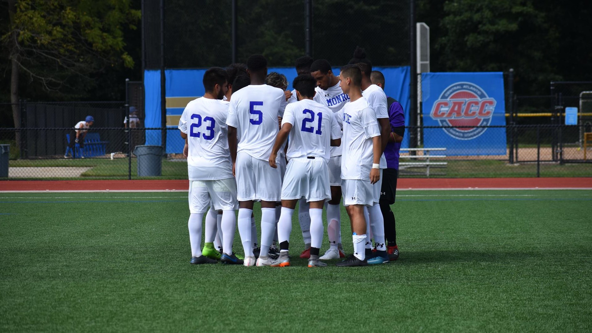 JV Men's Soccer Team Group Huddle