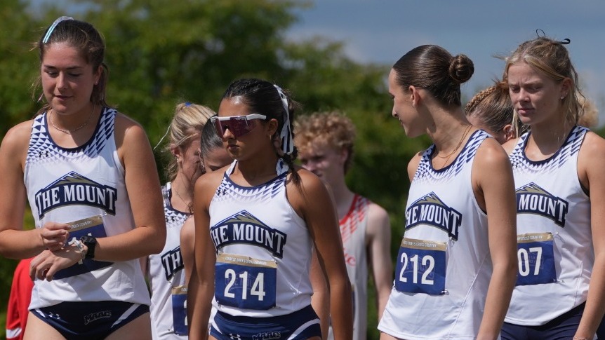 Four Cross Country Runners Line Up Before a Race Begins