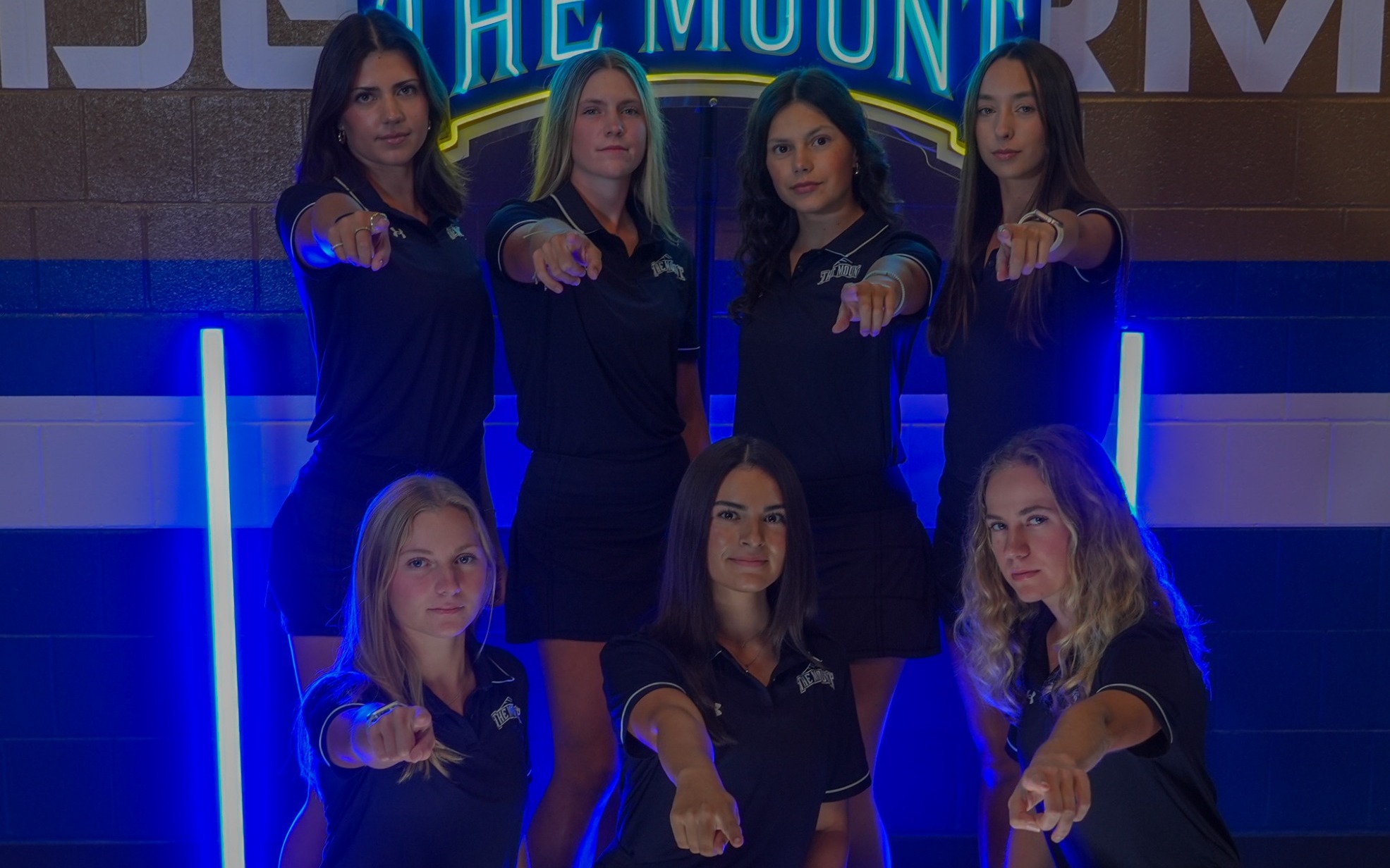 Women's Golf Team Points at Camera