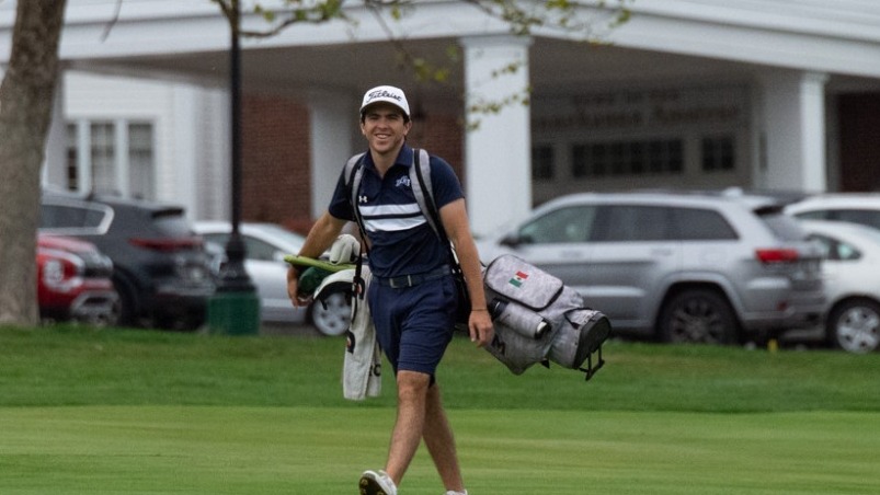 Santiago Bonequi Walking Across Green with Golf Bag