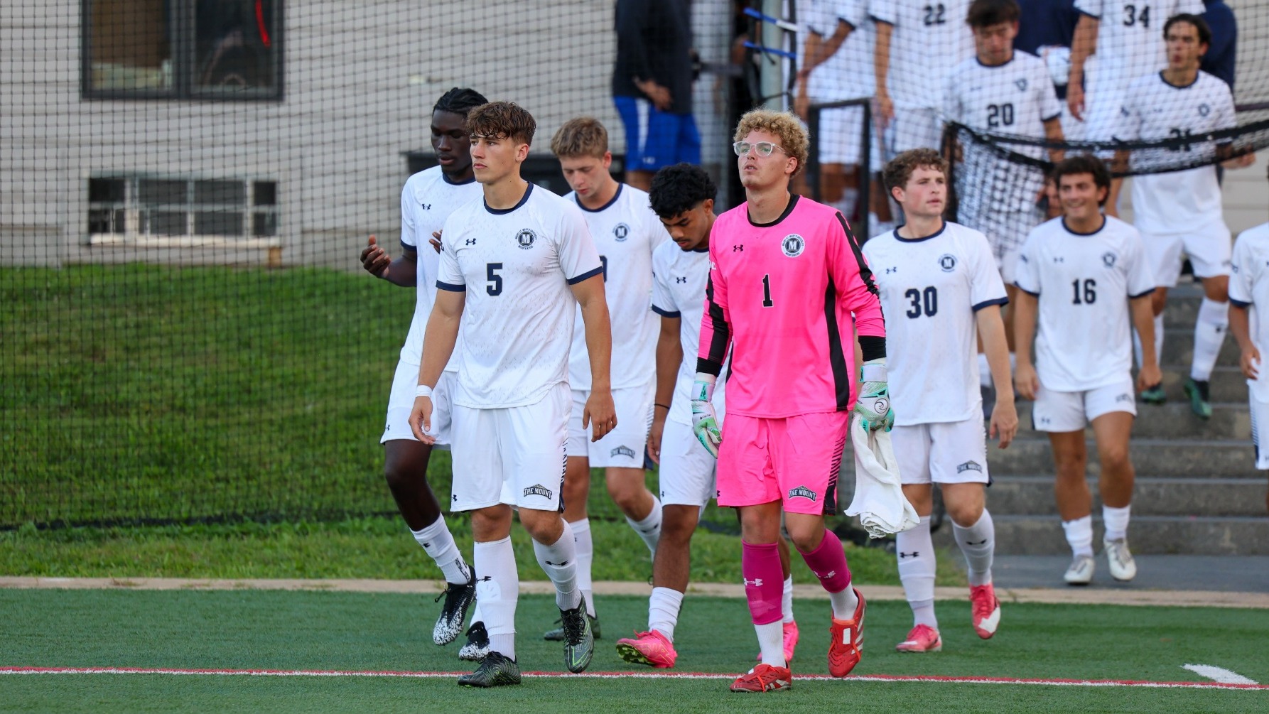 Ryan Collins and Noah Kaiser Lead the Group Out of the Locker Room Onto the Field