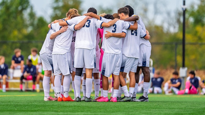 Men's Soccer Huddles During a Stoppage in Play
