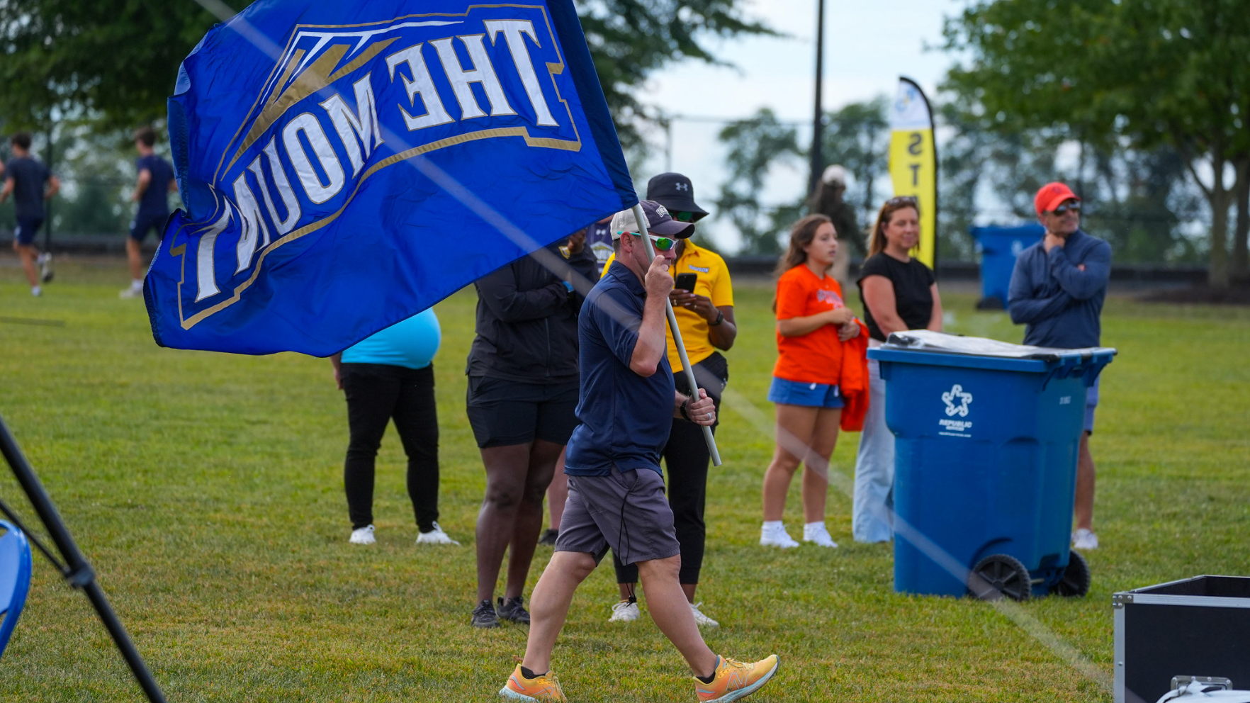 Coach Walking with Flag