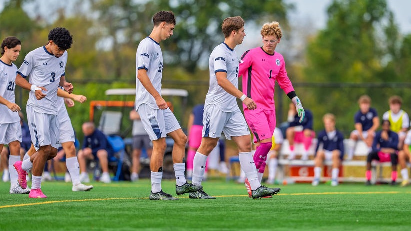 Members of the Men's Soccer Team Breaking a Huddle
