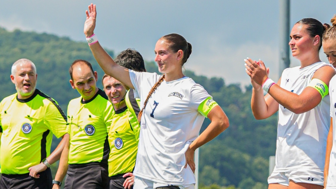 Lily Young Waves to the Crowd during the Lineup Introductions