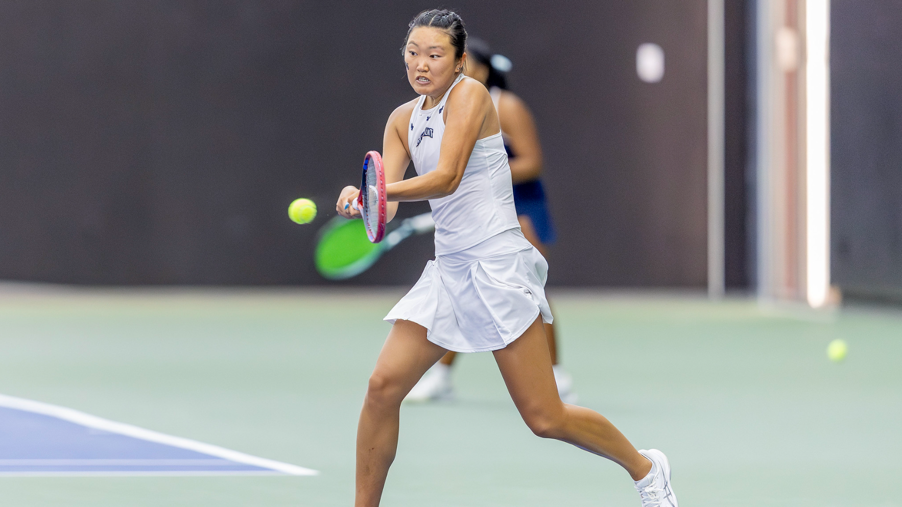 Venus Tang hitting a tennis ball in action