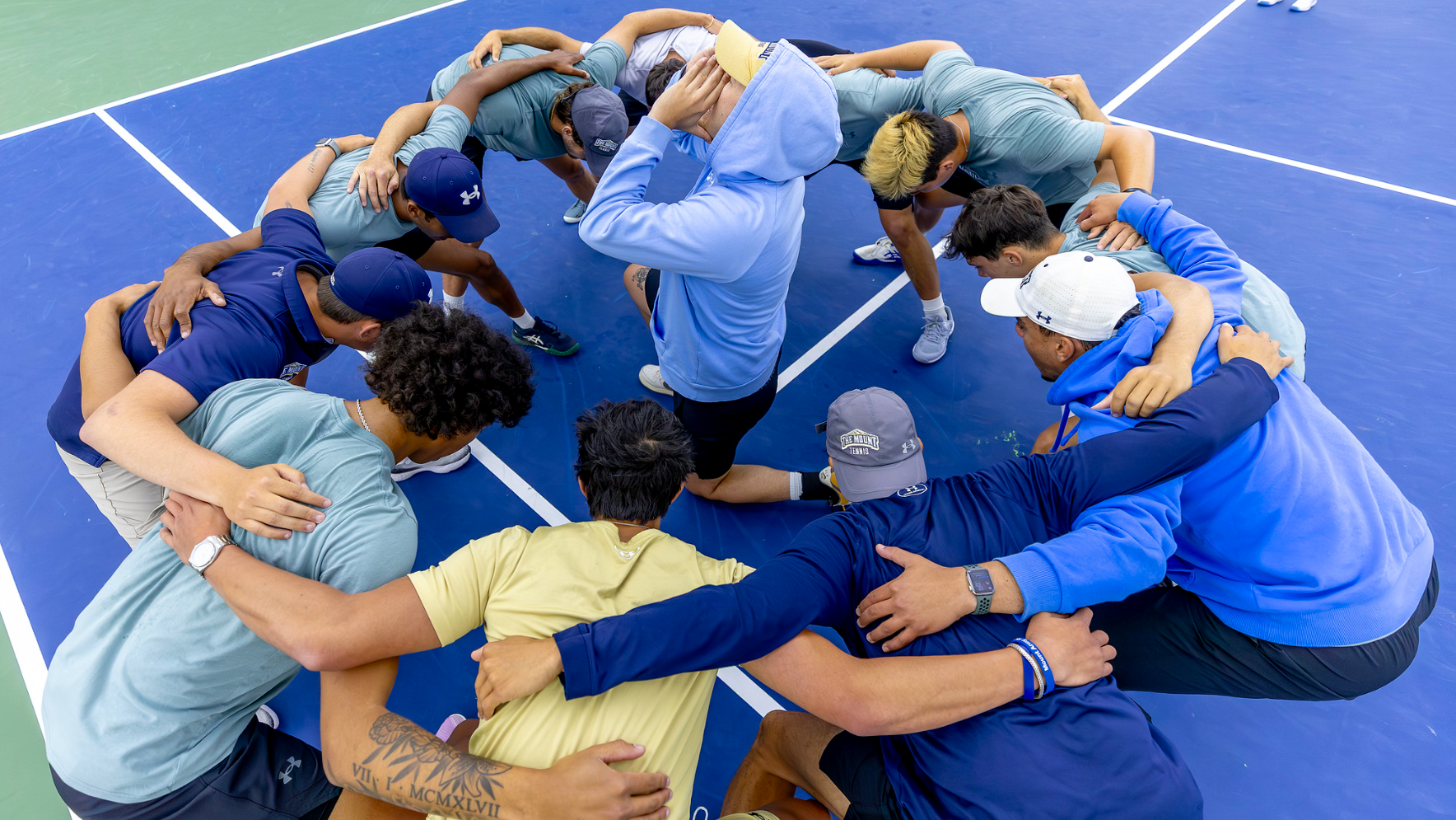 Men's tennis team huddled up