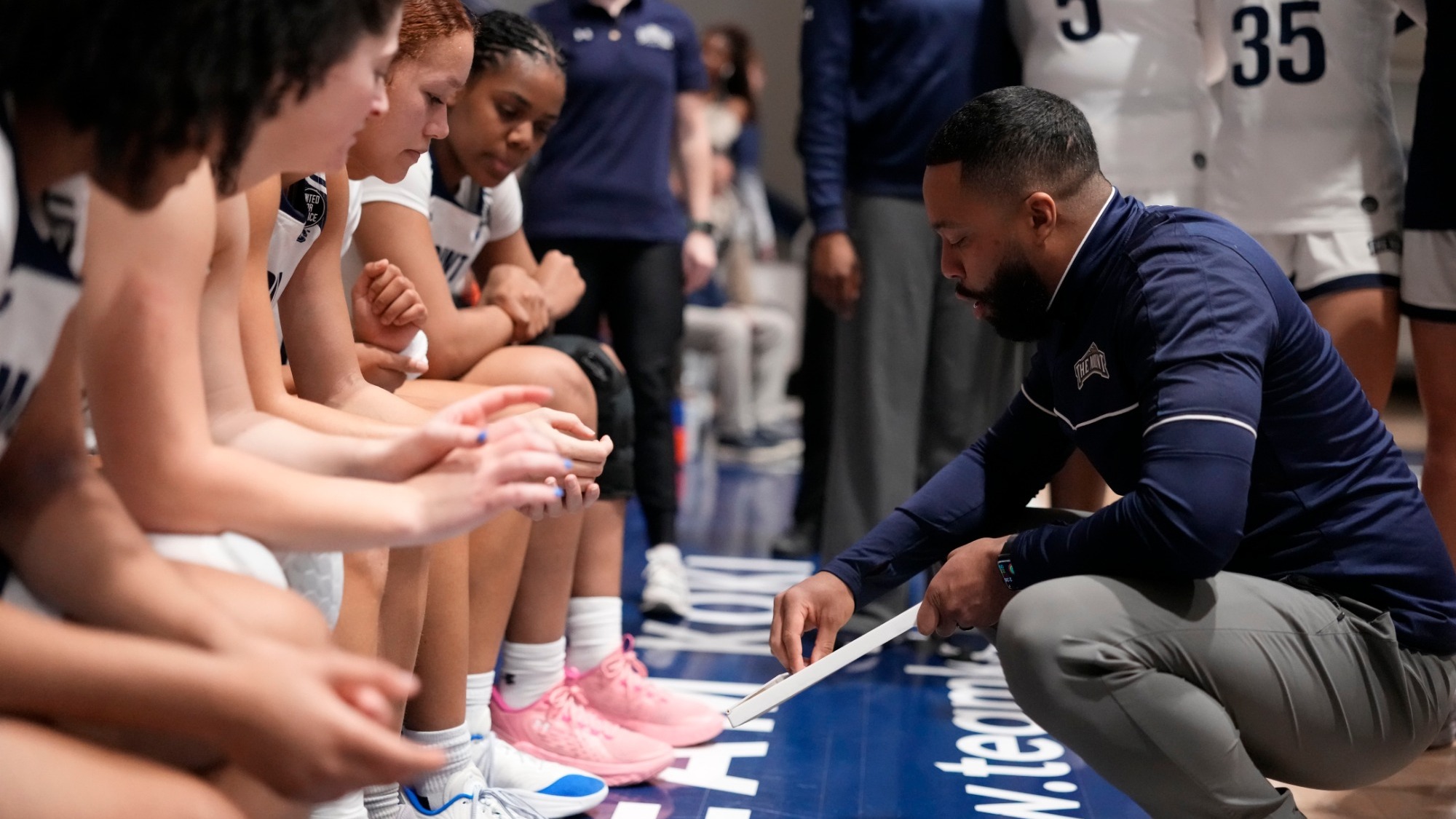 Antoine White Drawing Up a Play in the Huddle 