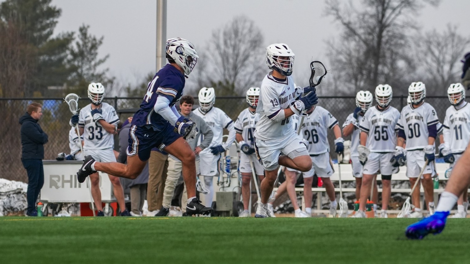 Marcelo Carreiro Cradling Past a Queens Defender as the Mount Bench Looks On