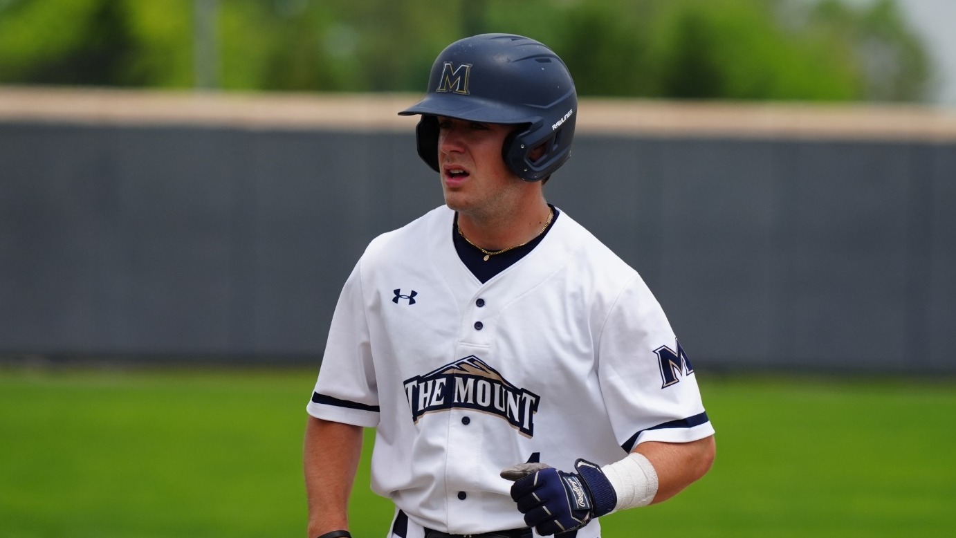 Evan Meier Looking in the Dugout Standing on First Base
