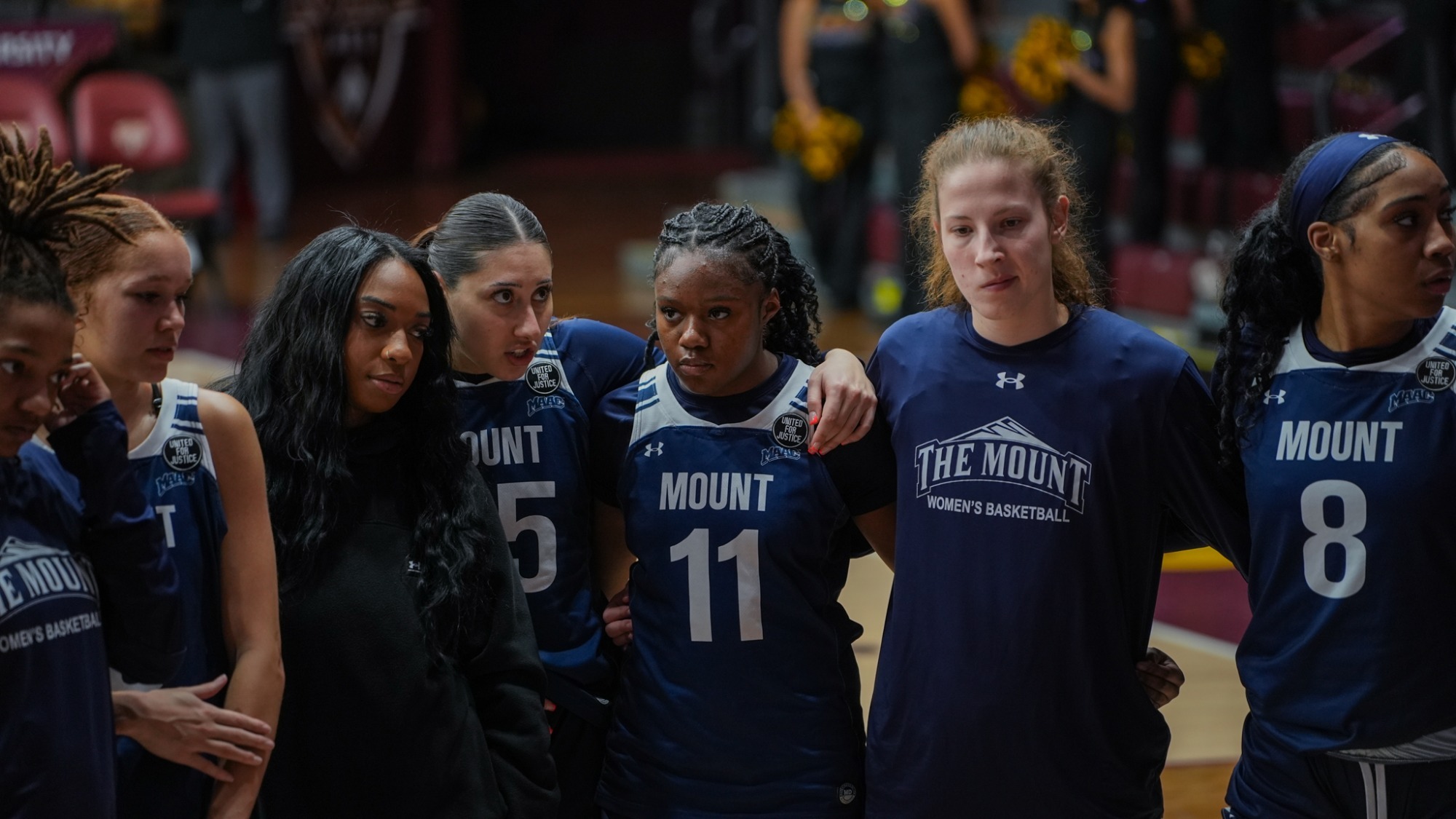 Three Mountaineers Looking Grim in the Huddle