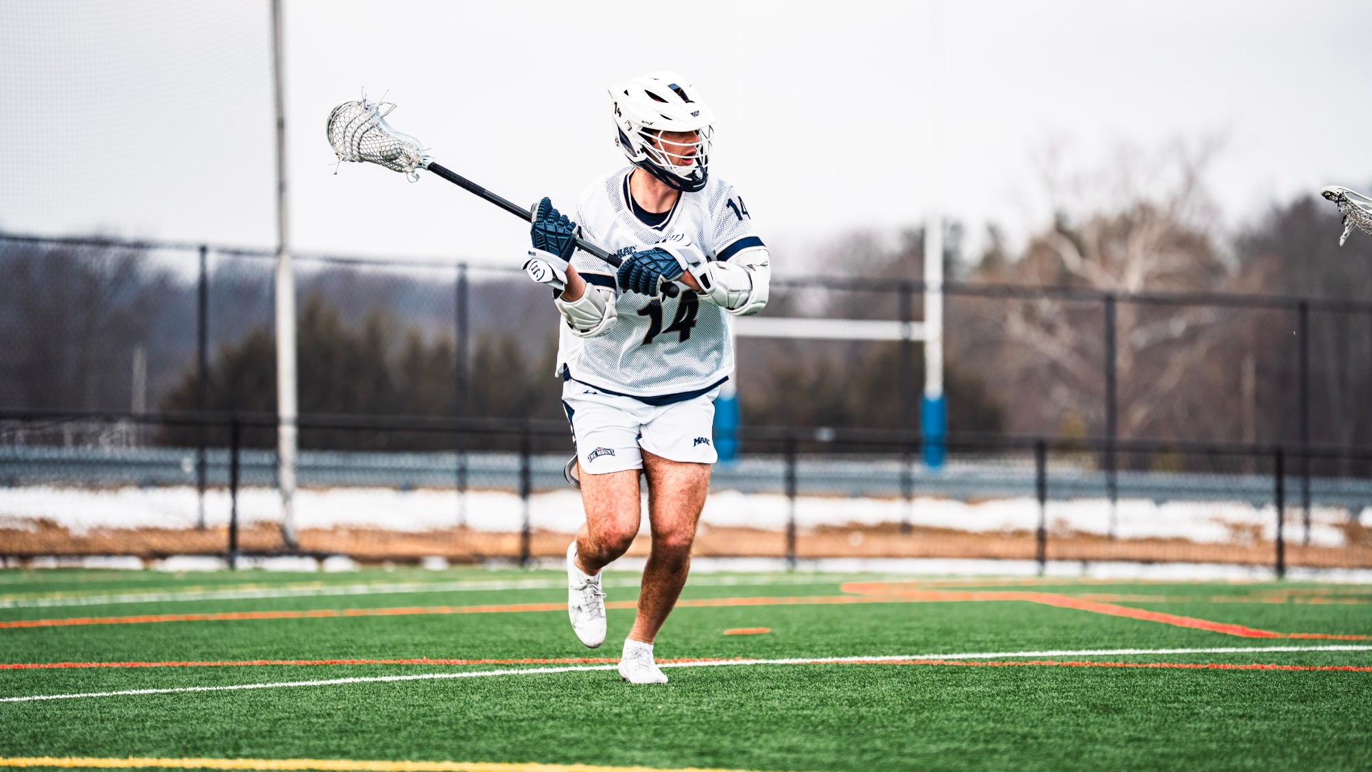 Brody Atkinson Cradling the Lacrosse Ball in the Field