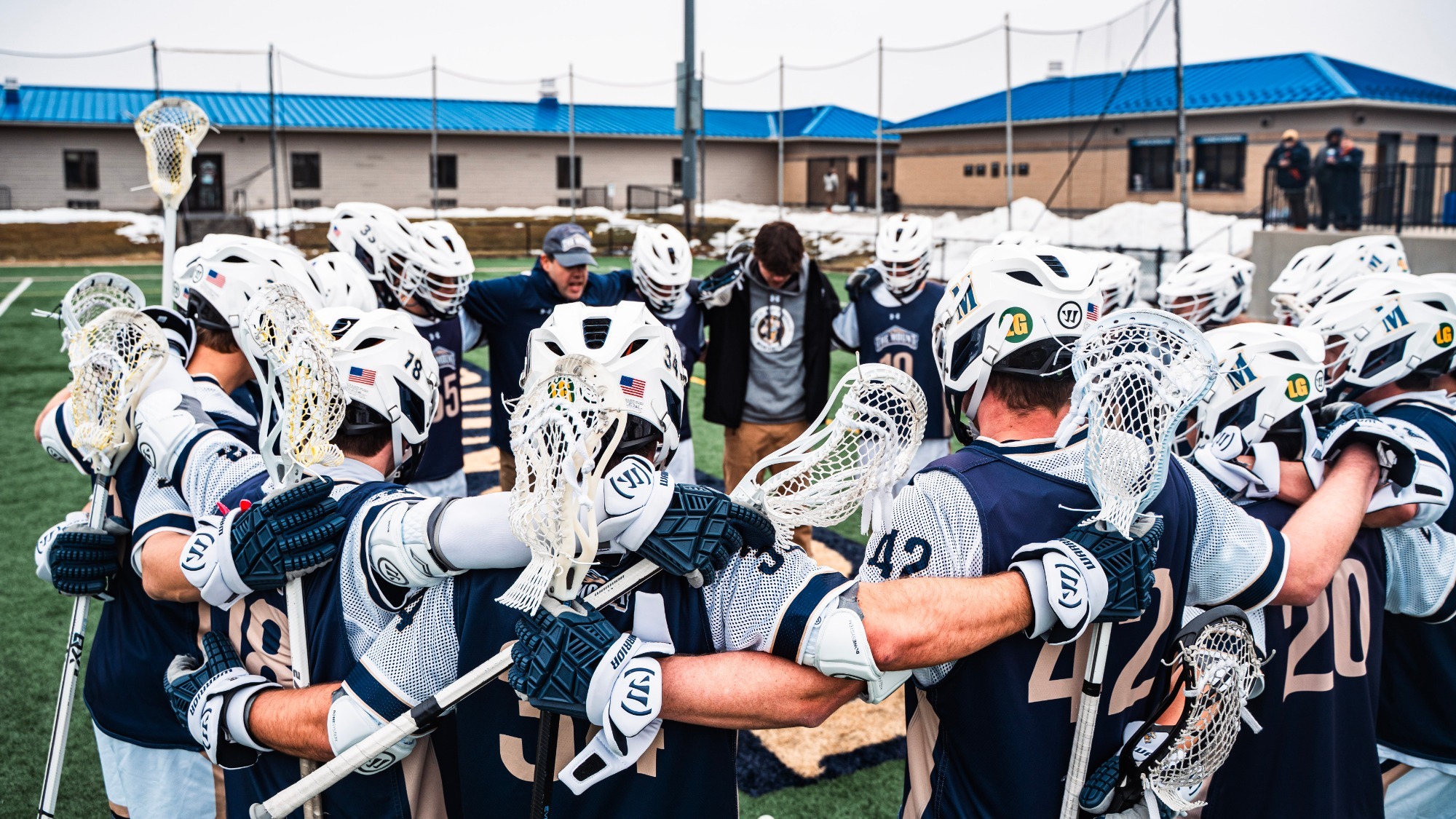 Mount Men's Lacrosse Huddle in Prayer and Contemplation Before a Game