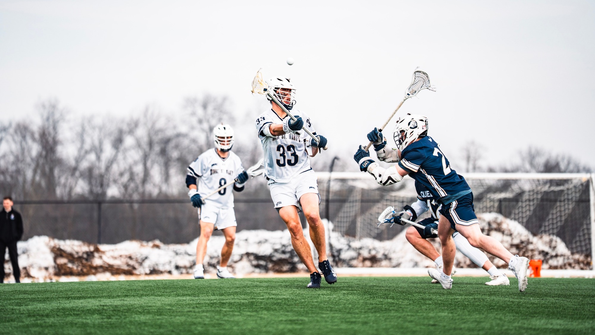 Dylan Sander Releases a Pass as Gavin Schaeffer Watches On