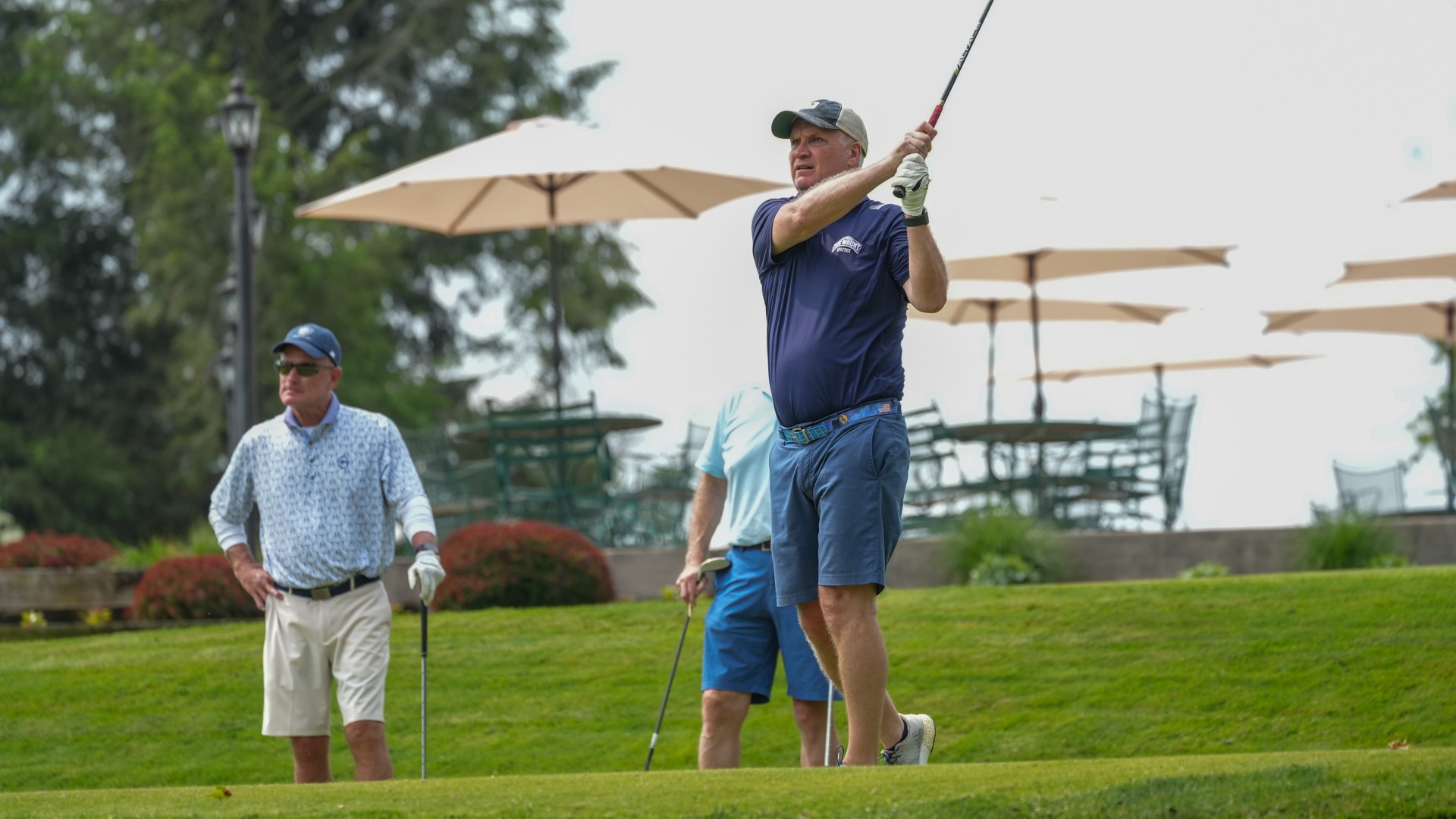 Emmits Open Participant Finishing a Golf Shot