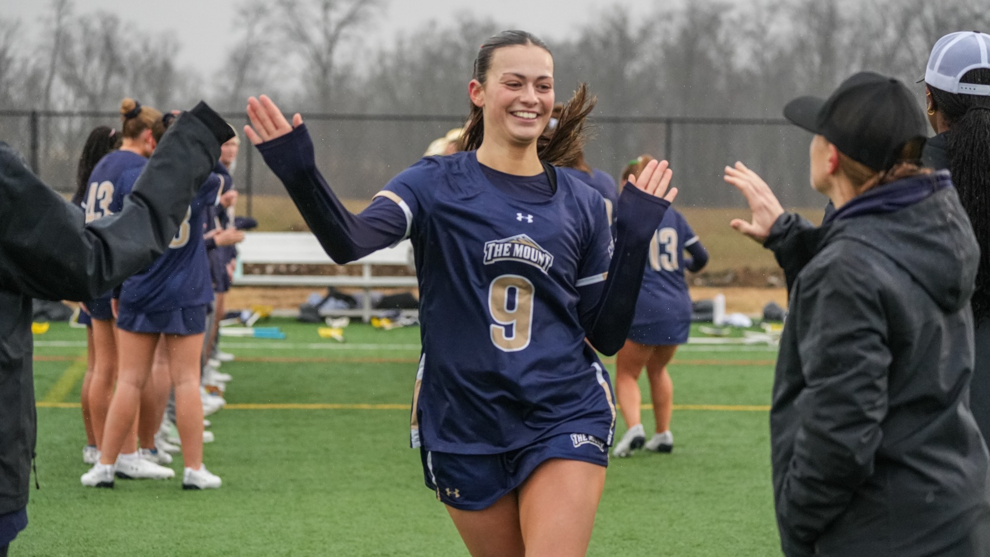 Brooke Molchanoff Smiling as She High Fives Coach Skellchock