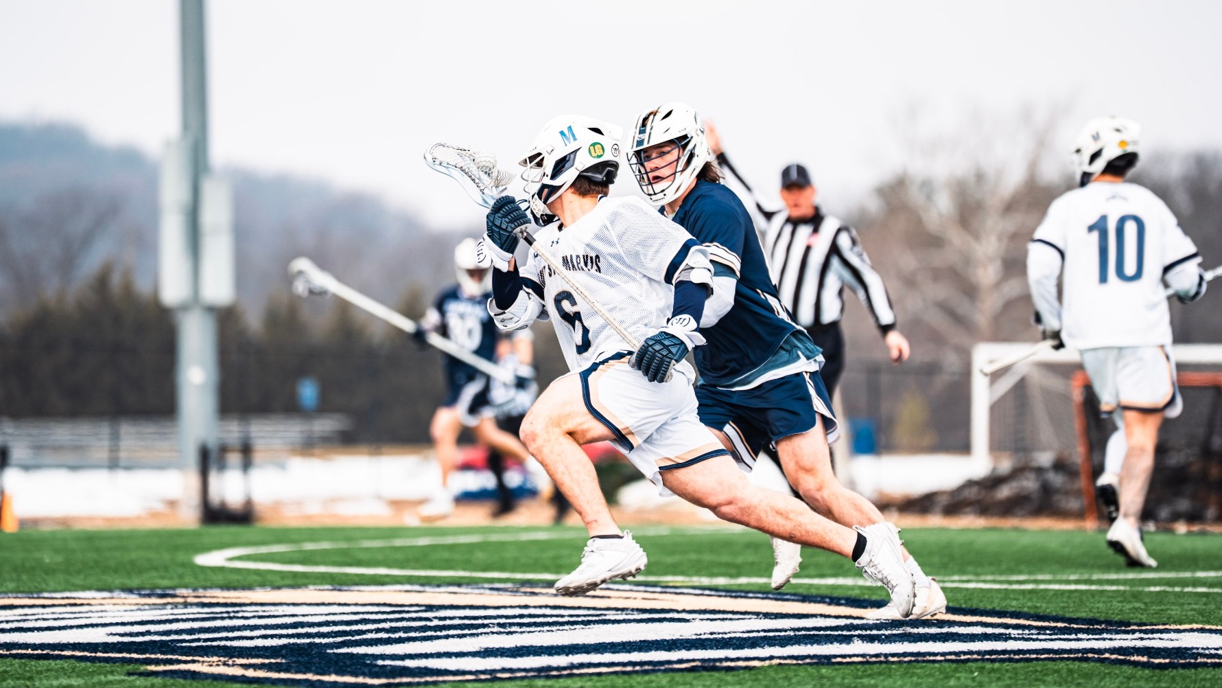 Nicolas Belmonte Rushes Past a Queens Defender