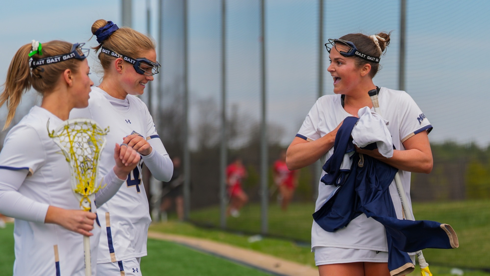 MK Allingham Smiling in Conversation with Mackey Fick and Ella Curci