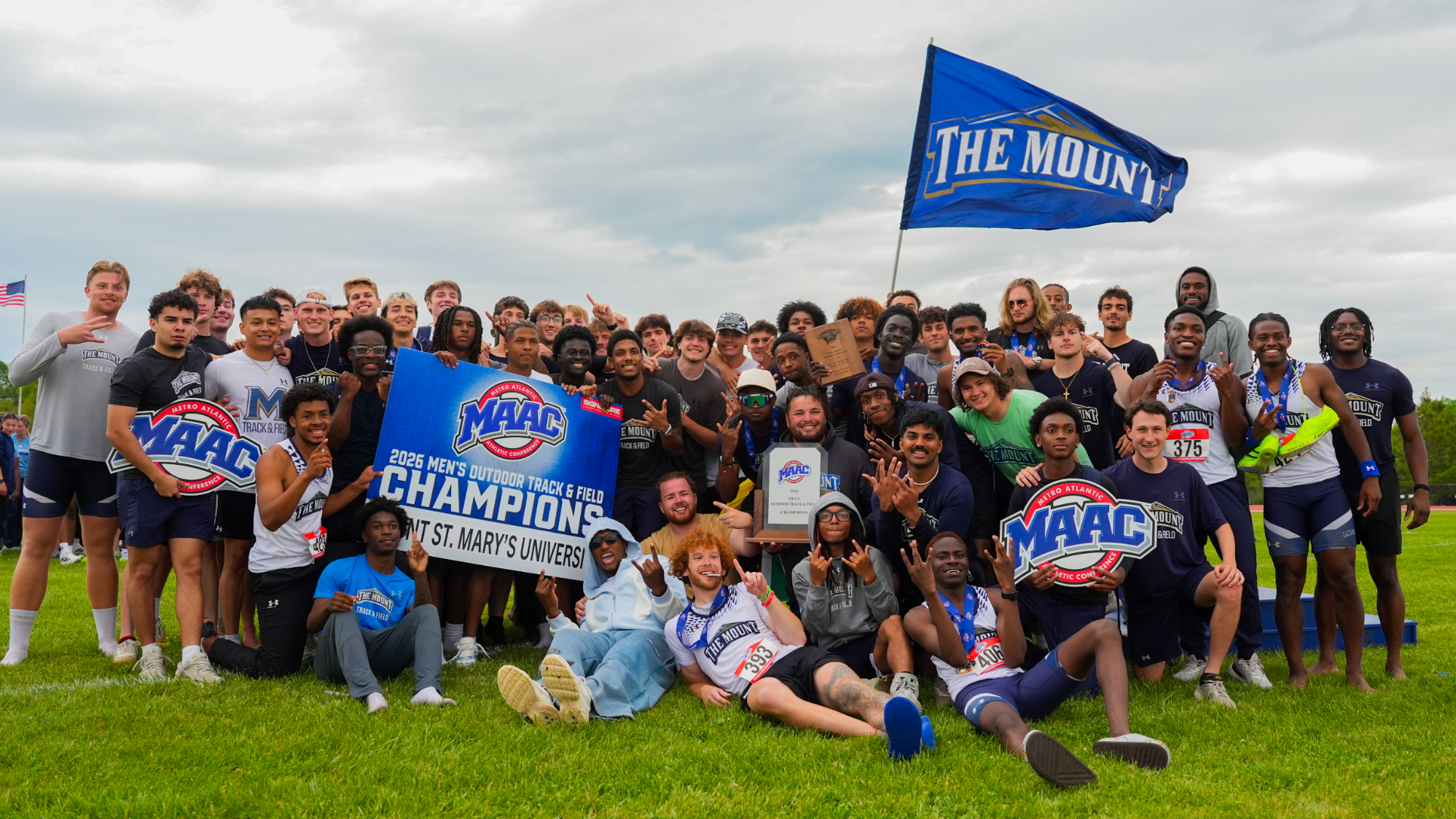 Mount St. Mary's men's track & field posing with their championship items